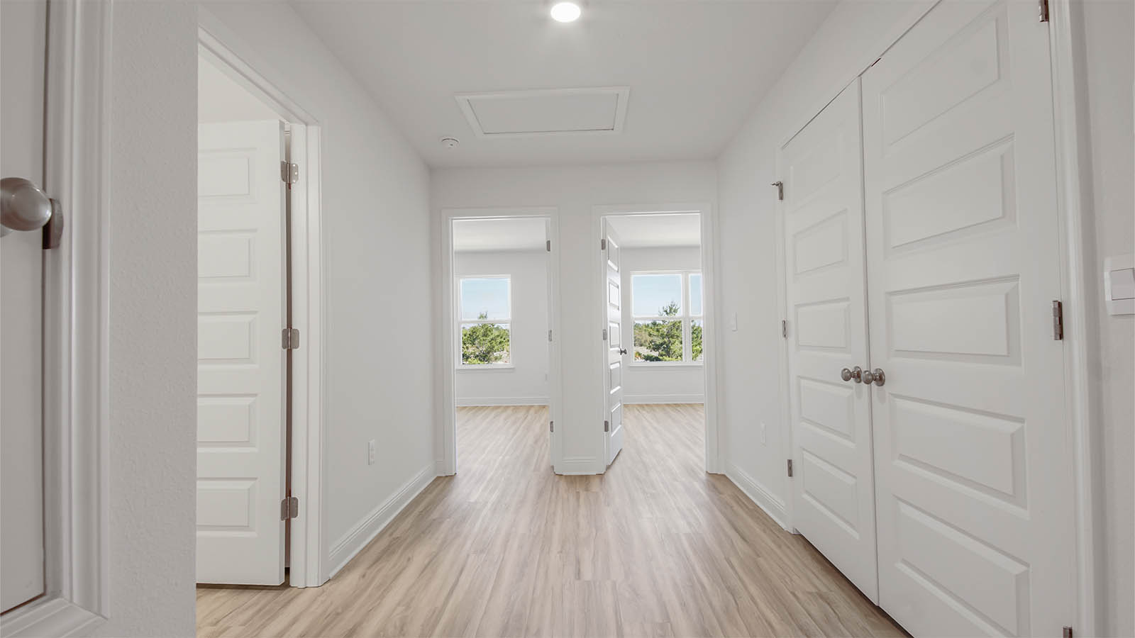 Hallway with EVP flooring and bathroom and bedroom entrances.