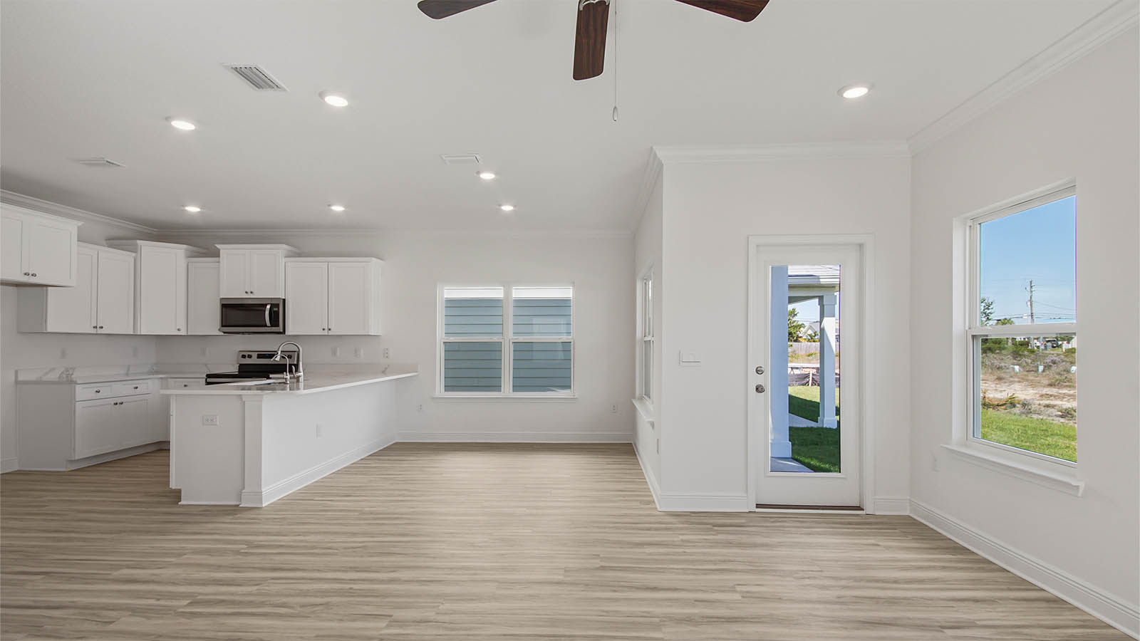 Living room and dining area with EVP flooring and back door.