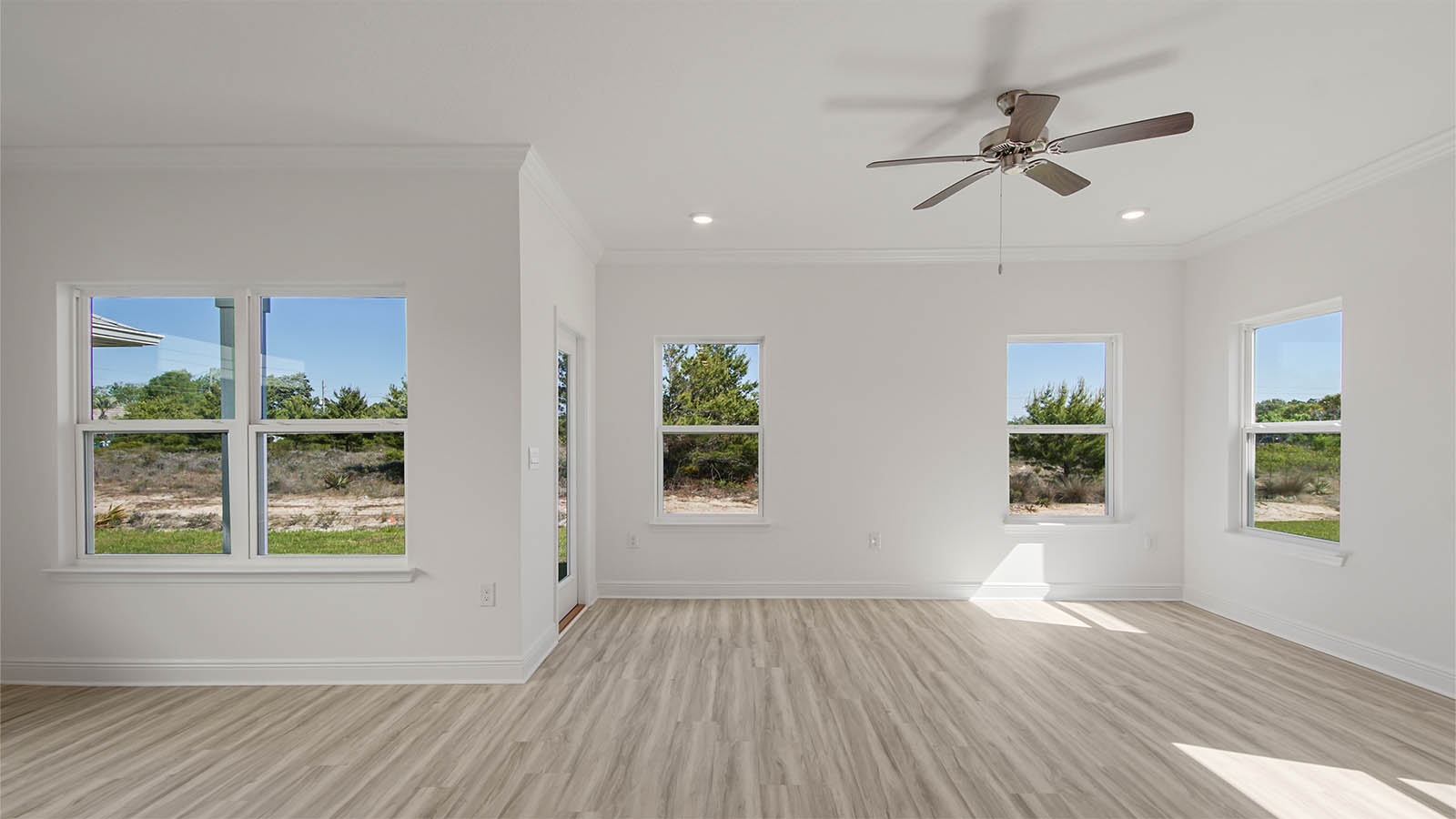Living room and dining area with EVP flooring and back door.