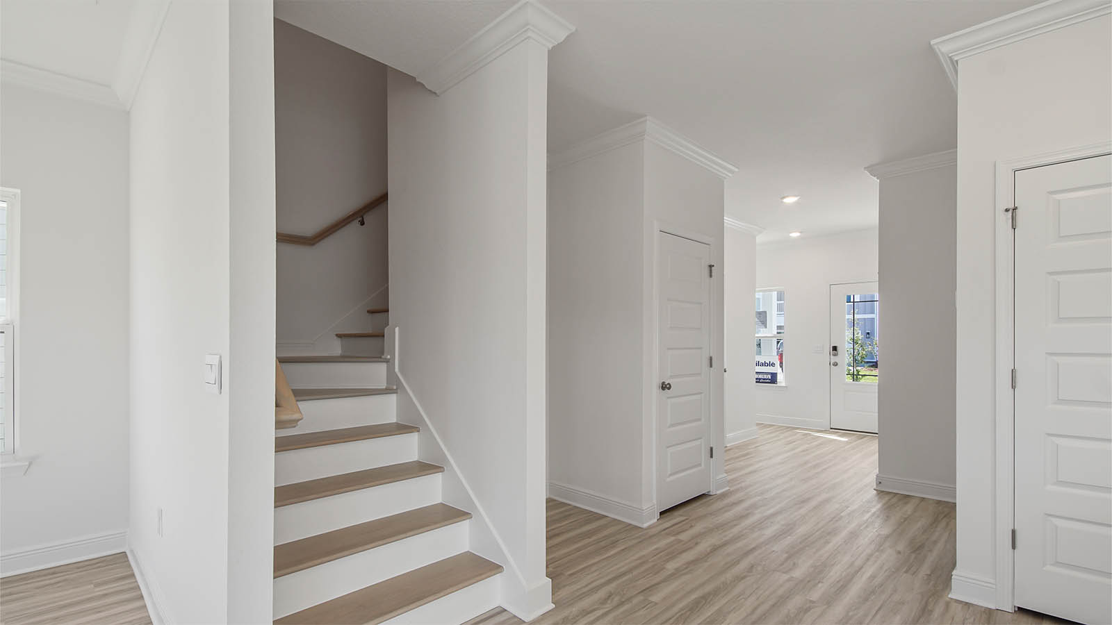 Hallway with stairs and foyer.