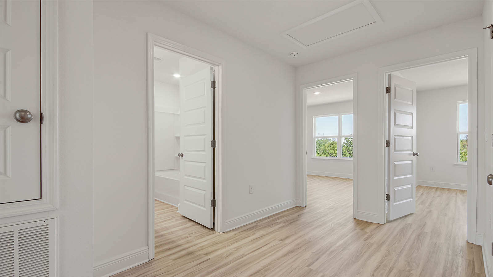 Hallway with EVP flooring and bathroom and bedroom entrances.