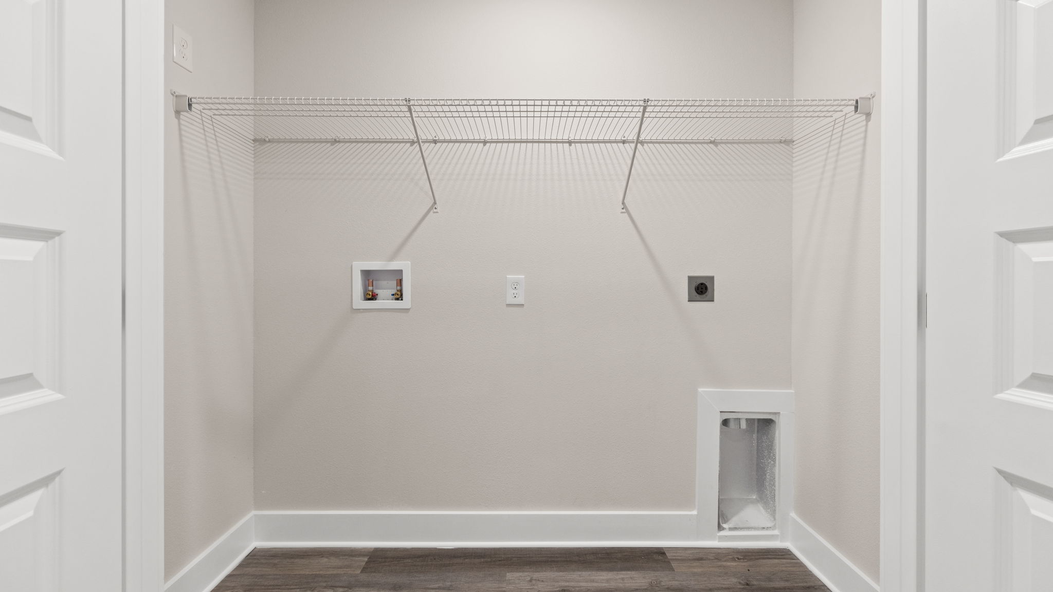 Laundry room with EVP flooring and shelving.