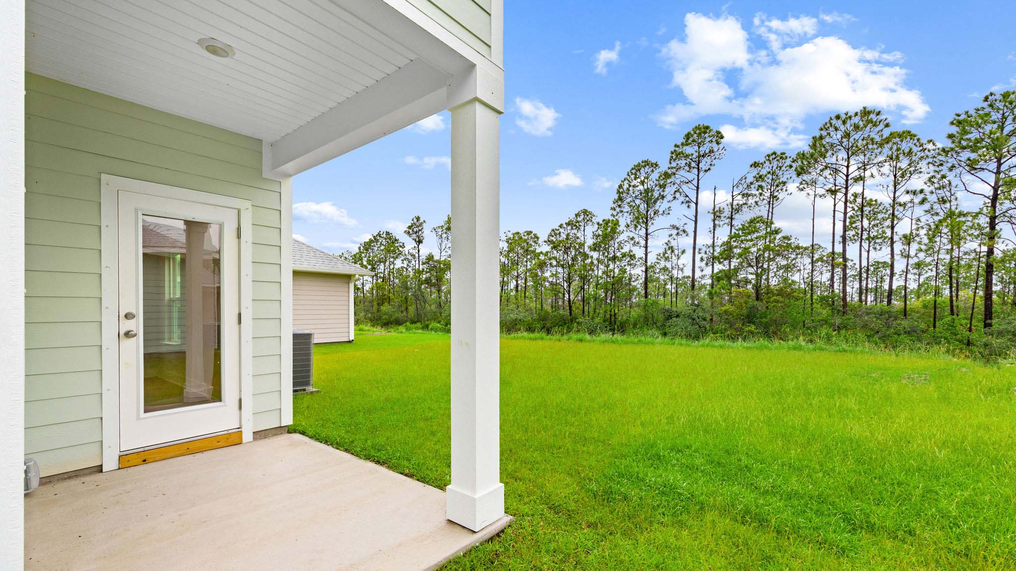 Covered back patio and back yard view.