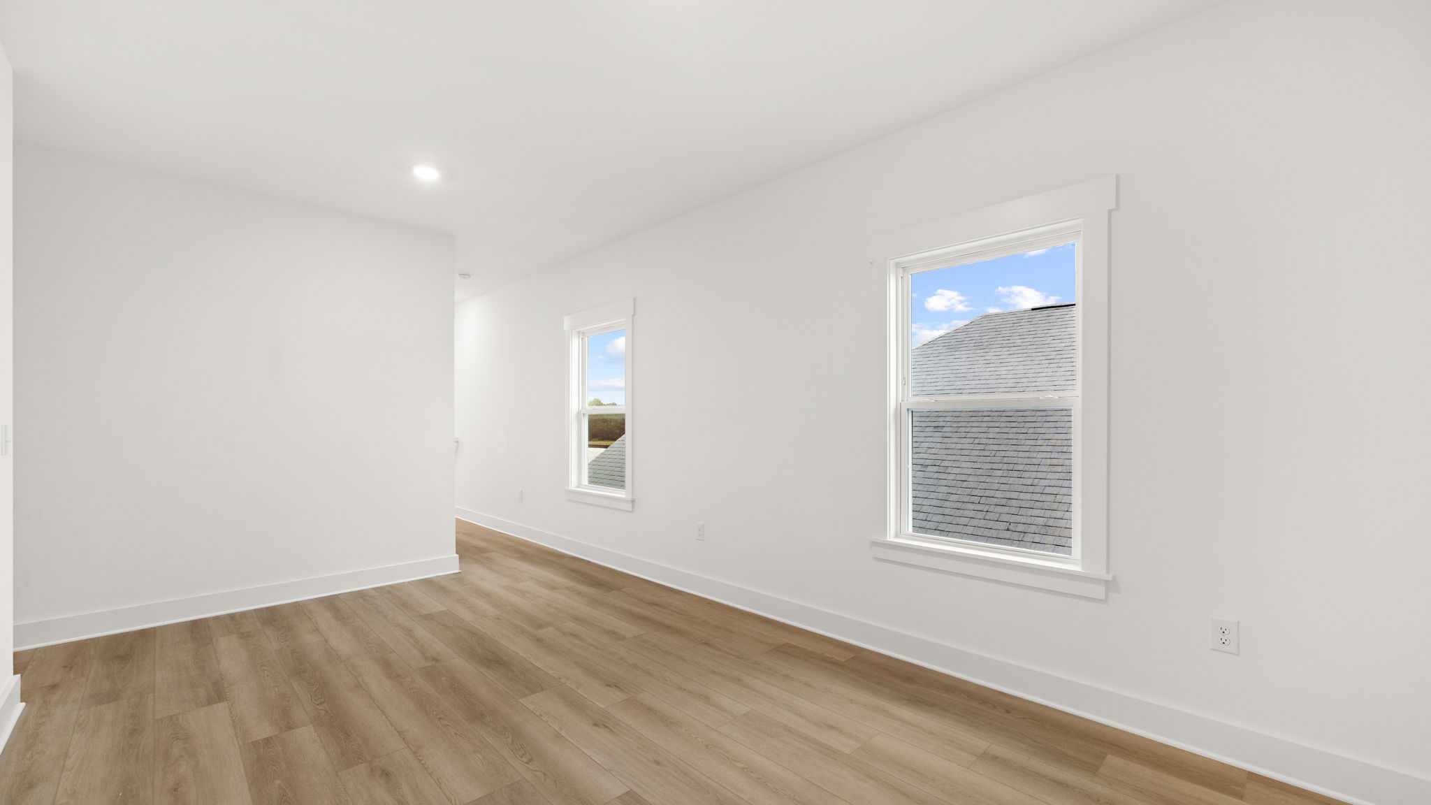 Upstairs bonus area with EVP flooring and windows.