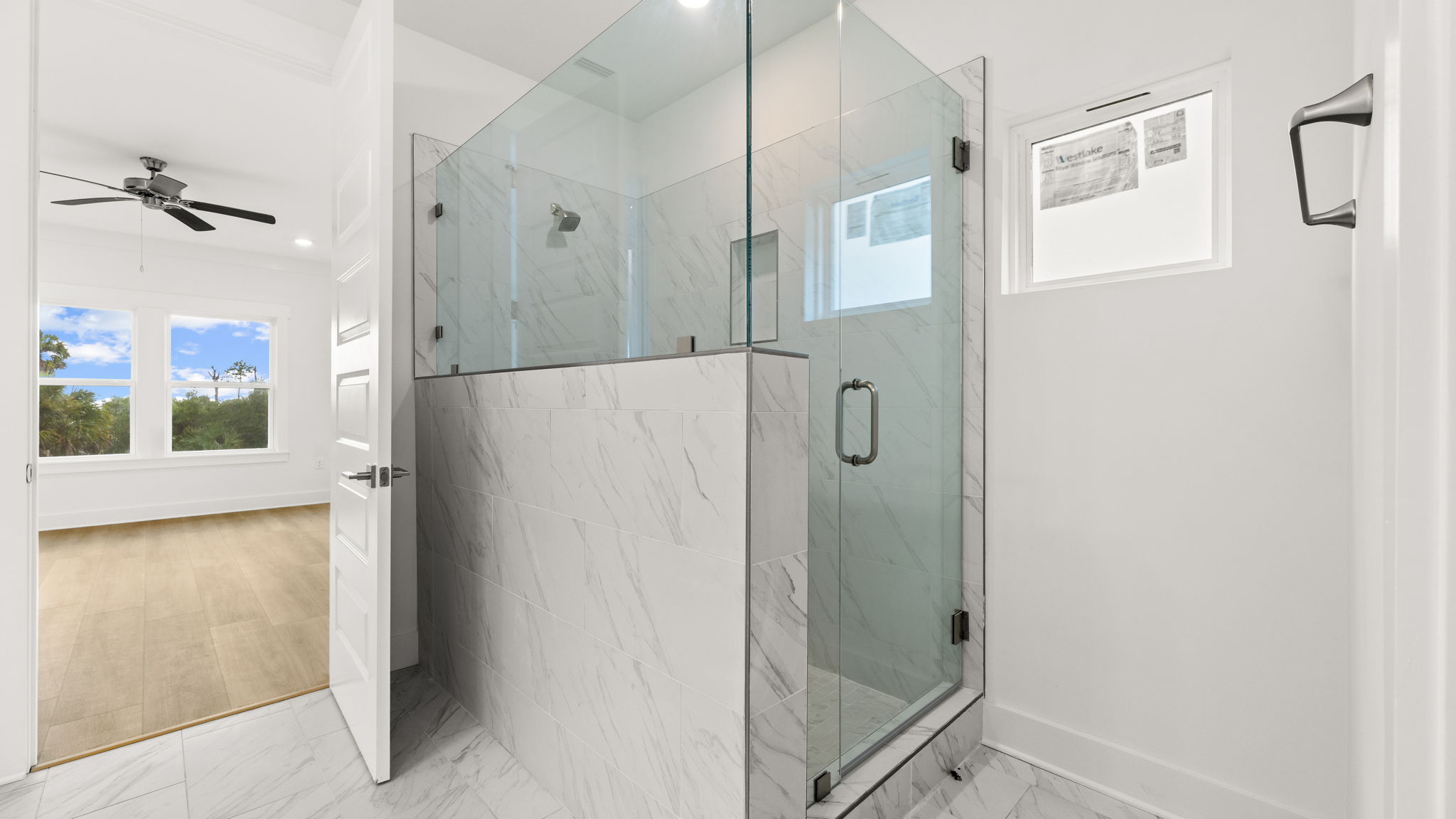 Tile shower with glass door.