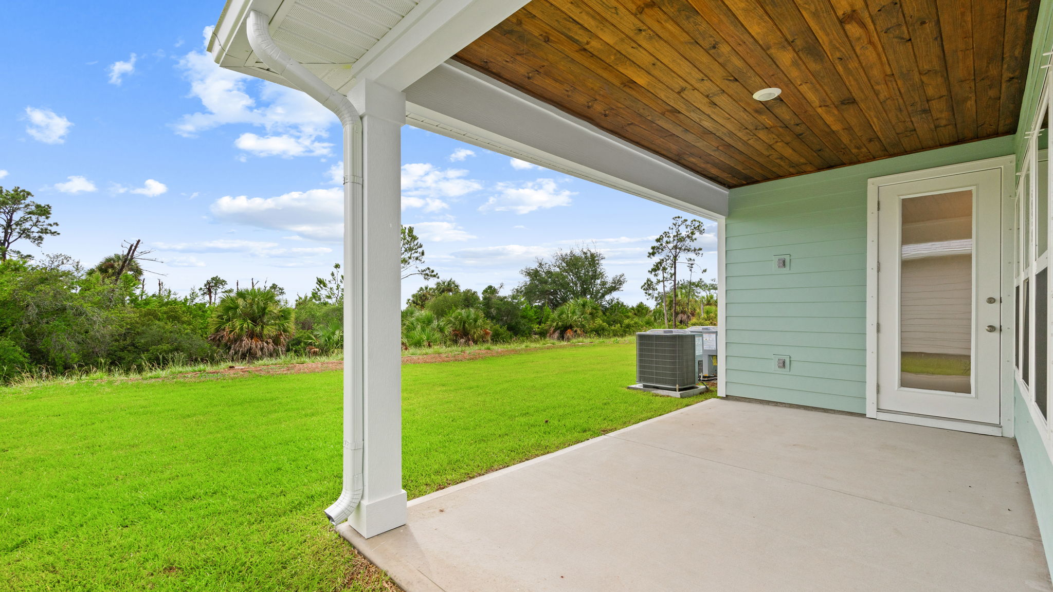 Covered back patio and view of back yard.