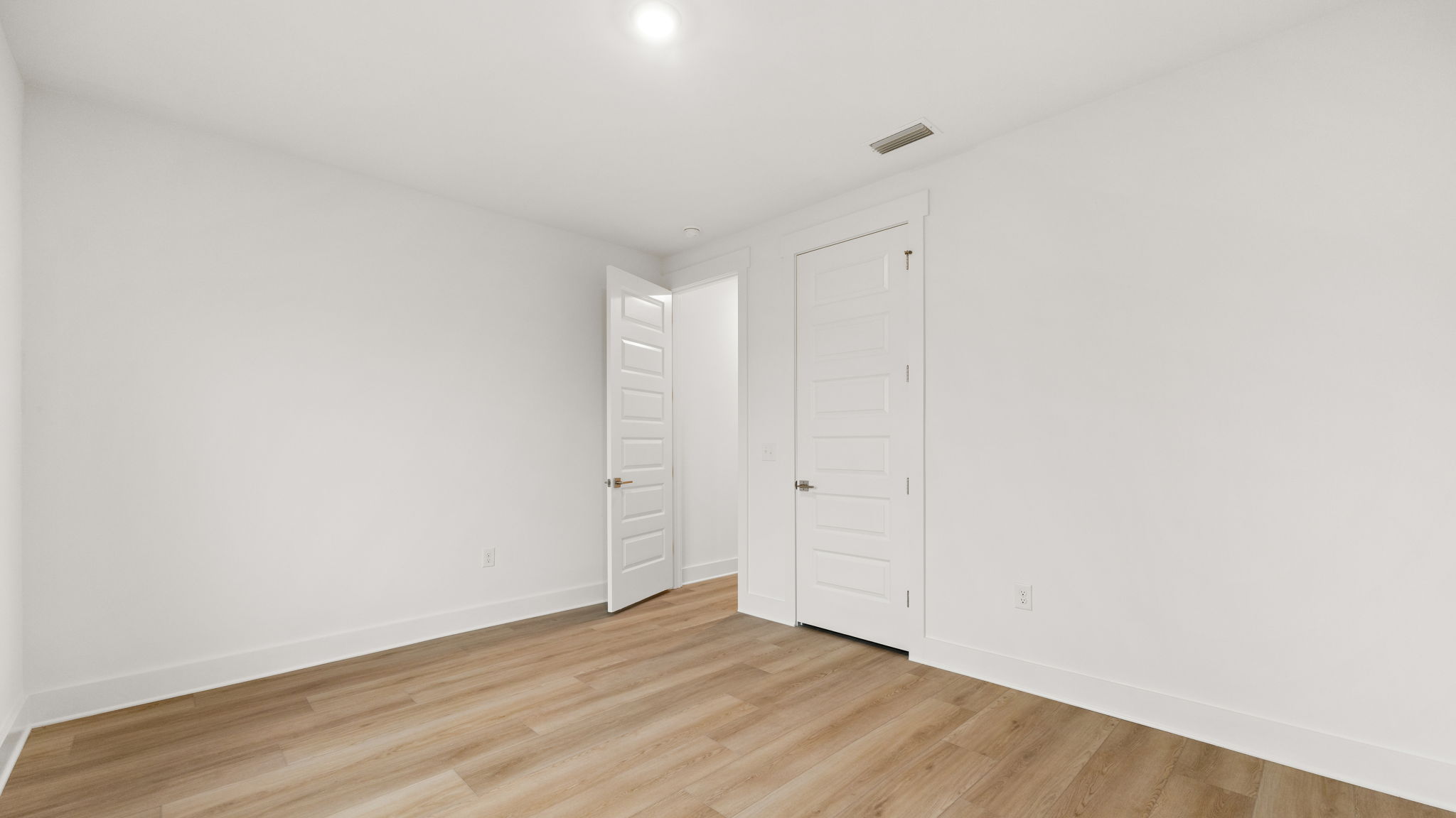 Bedroom with EVP flooring and closet.