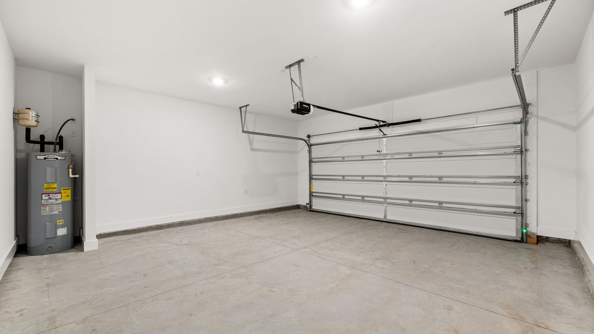 Two-car garage with water heater.