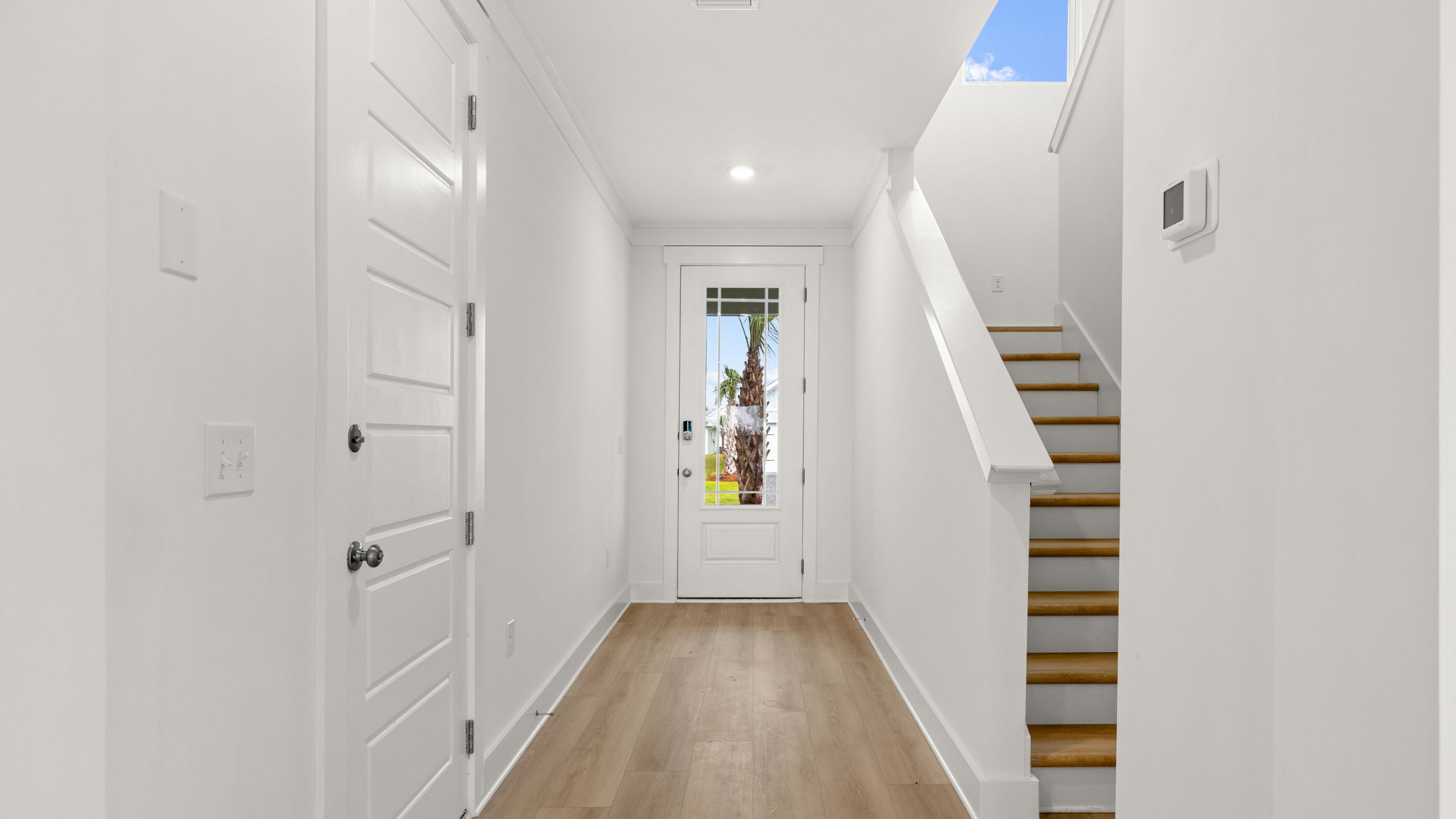 Front entrance next to stairs and garage door.