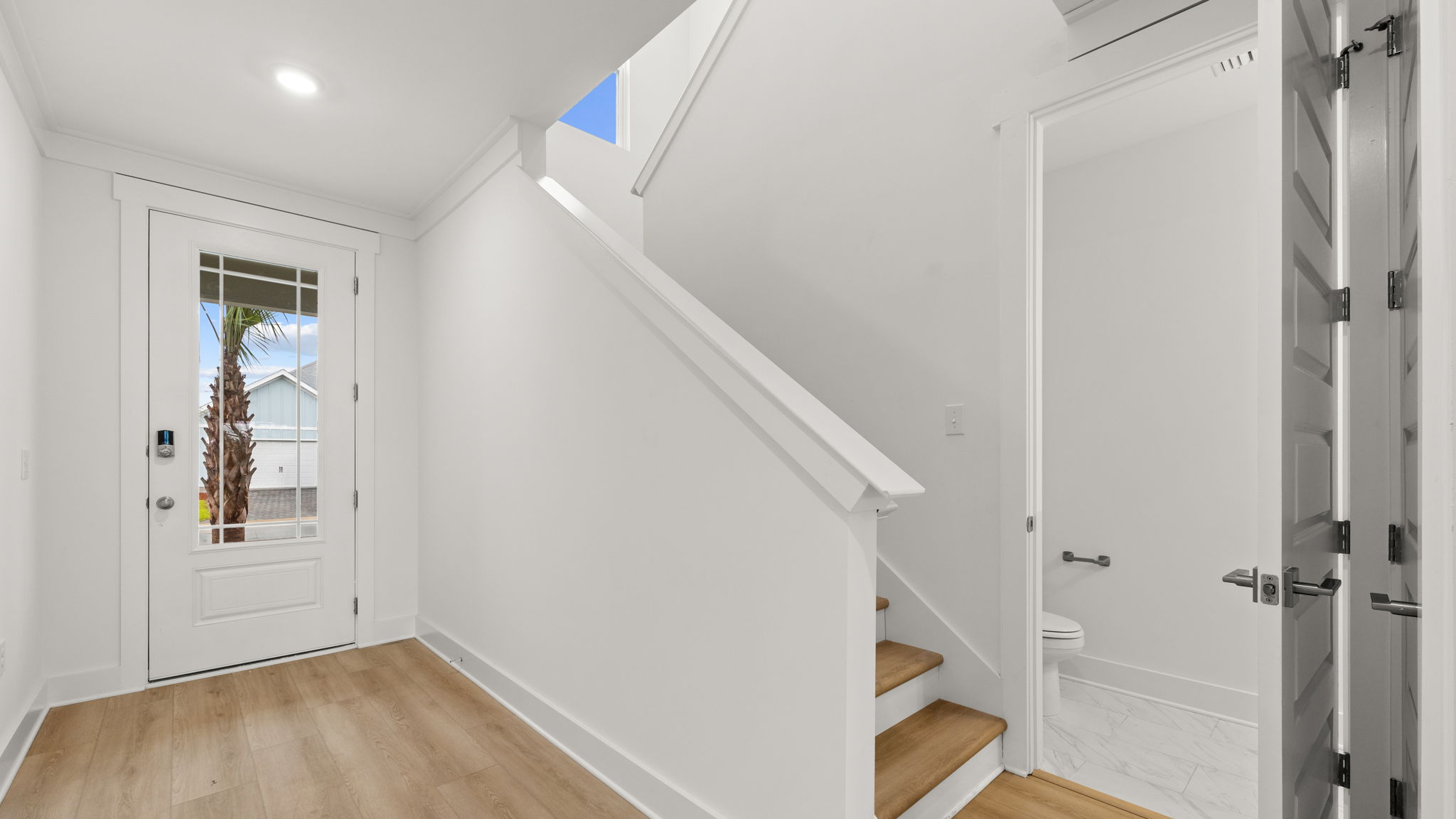 Staircase next to closet and bathroom.