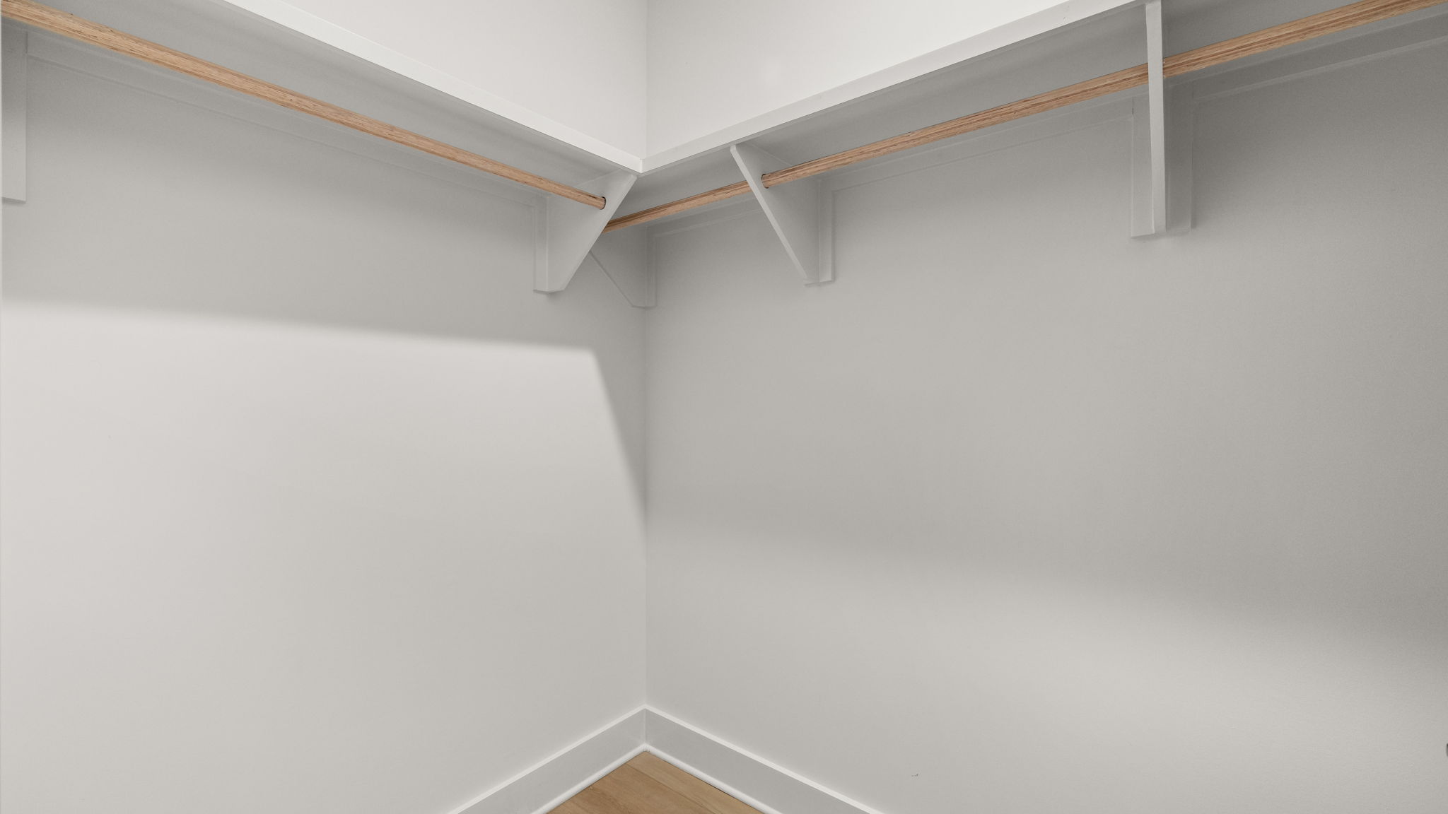 Closet with EVP flooring and wood shelving.