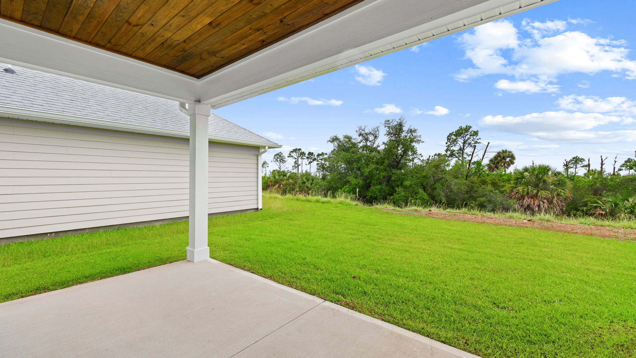 Covered back patio and view of back yard.