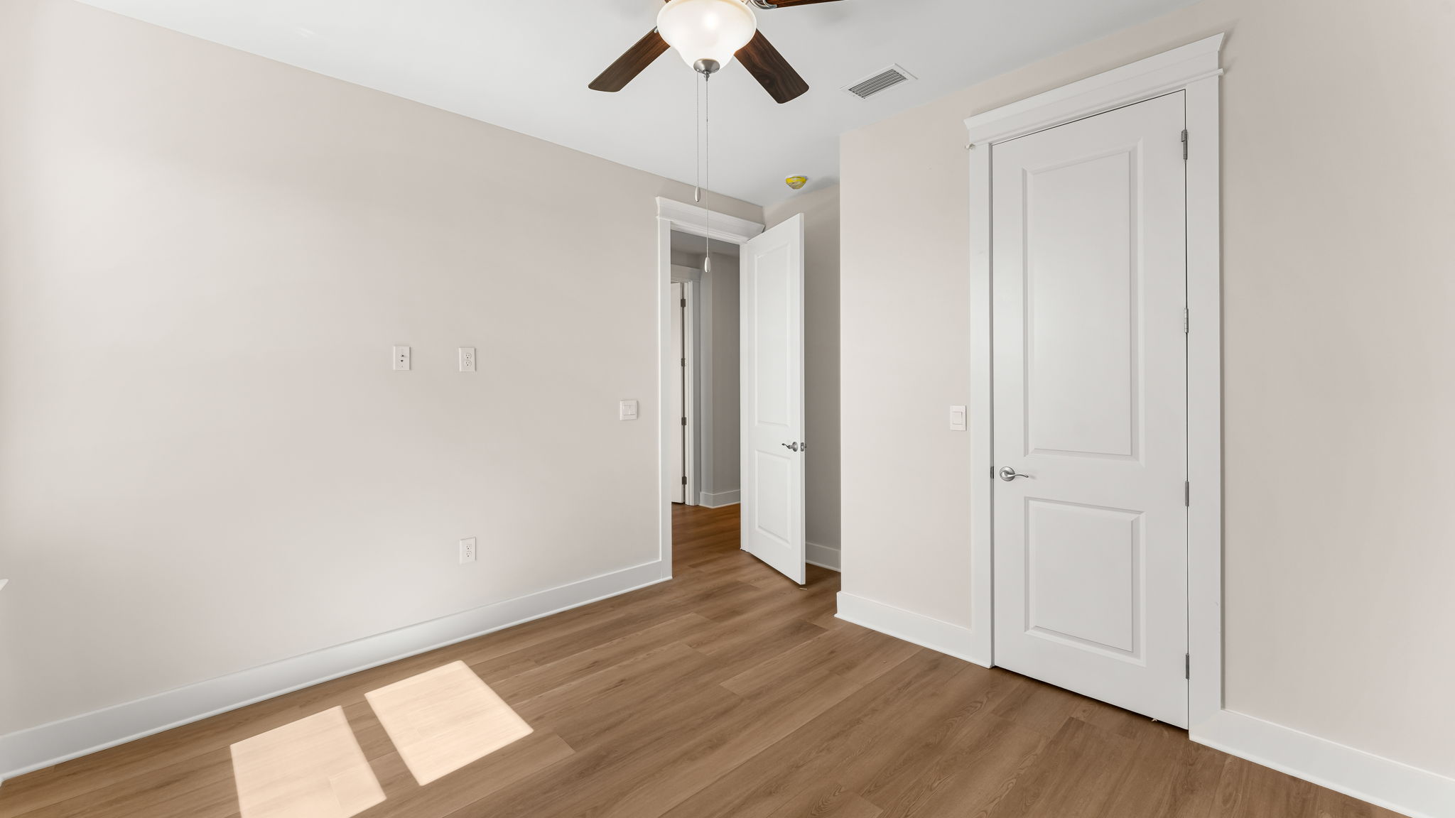 Bedroom with EVP flooring and closet and ceiling fan.