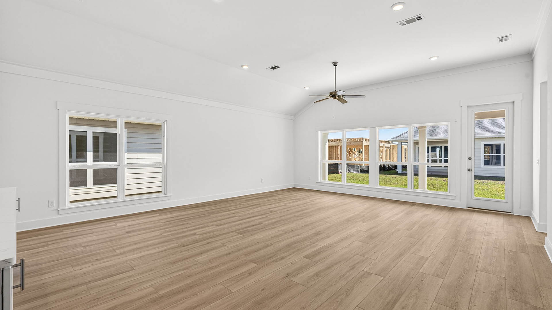 Open living room with ceiling fan and EVP flooring.