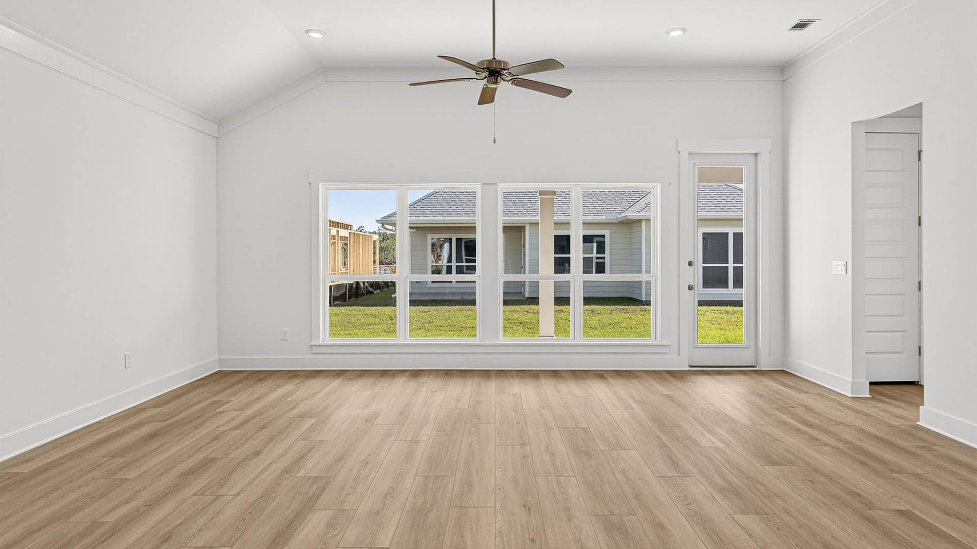 Open living room with ceiling fan and EVP flooring.