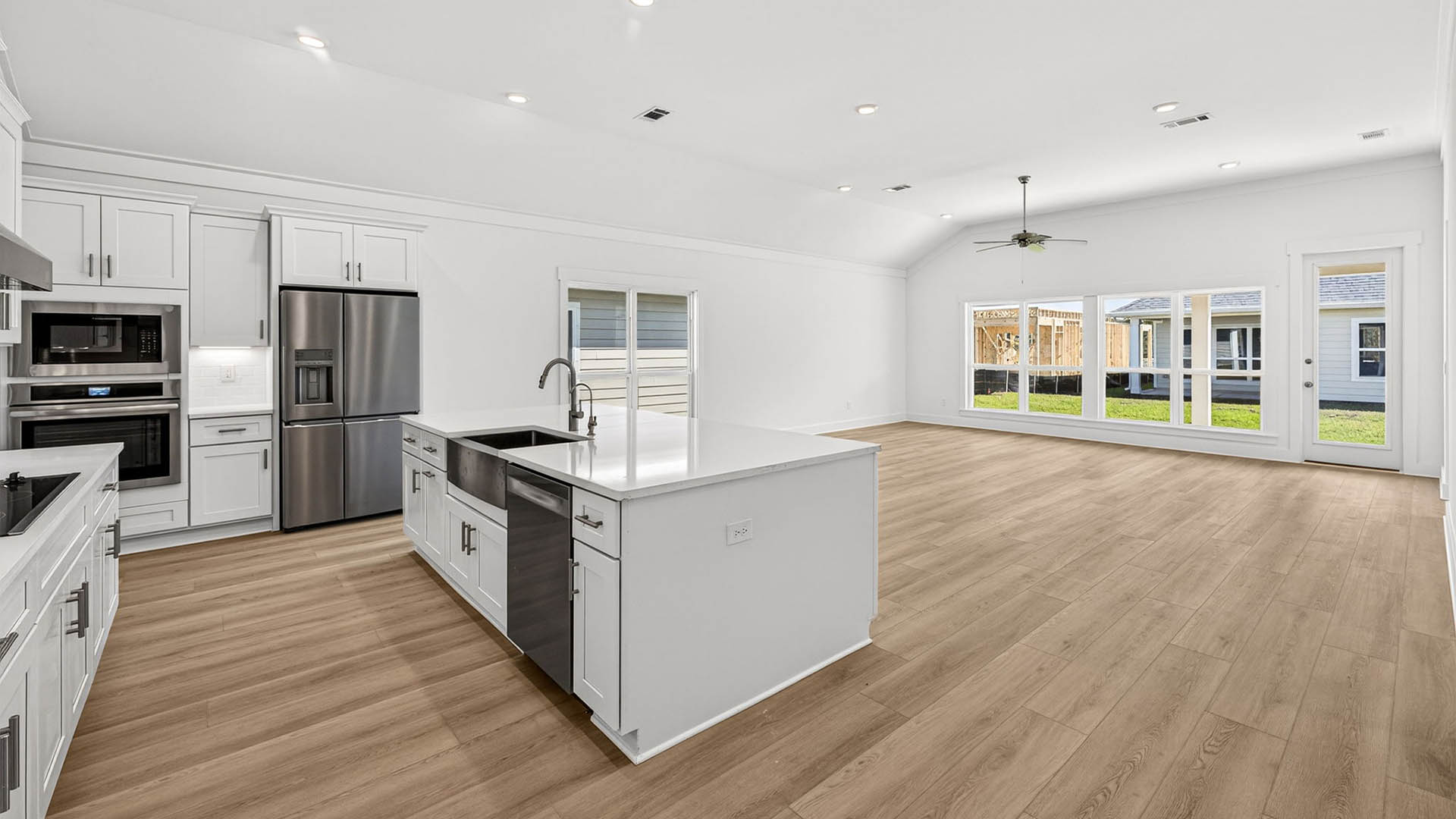 Open living room and kitchen with kitchen island.