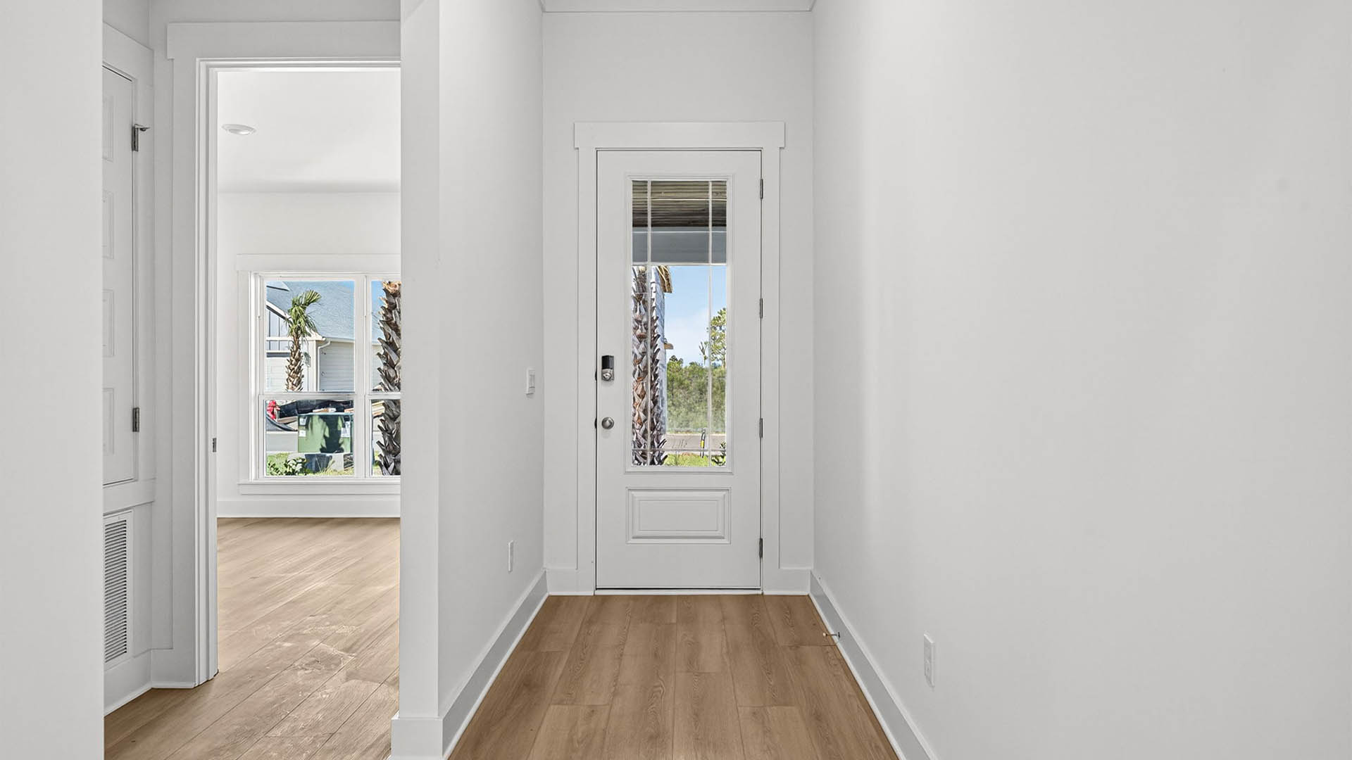 Front entrance next to bedrooms with prairie style front door.