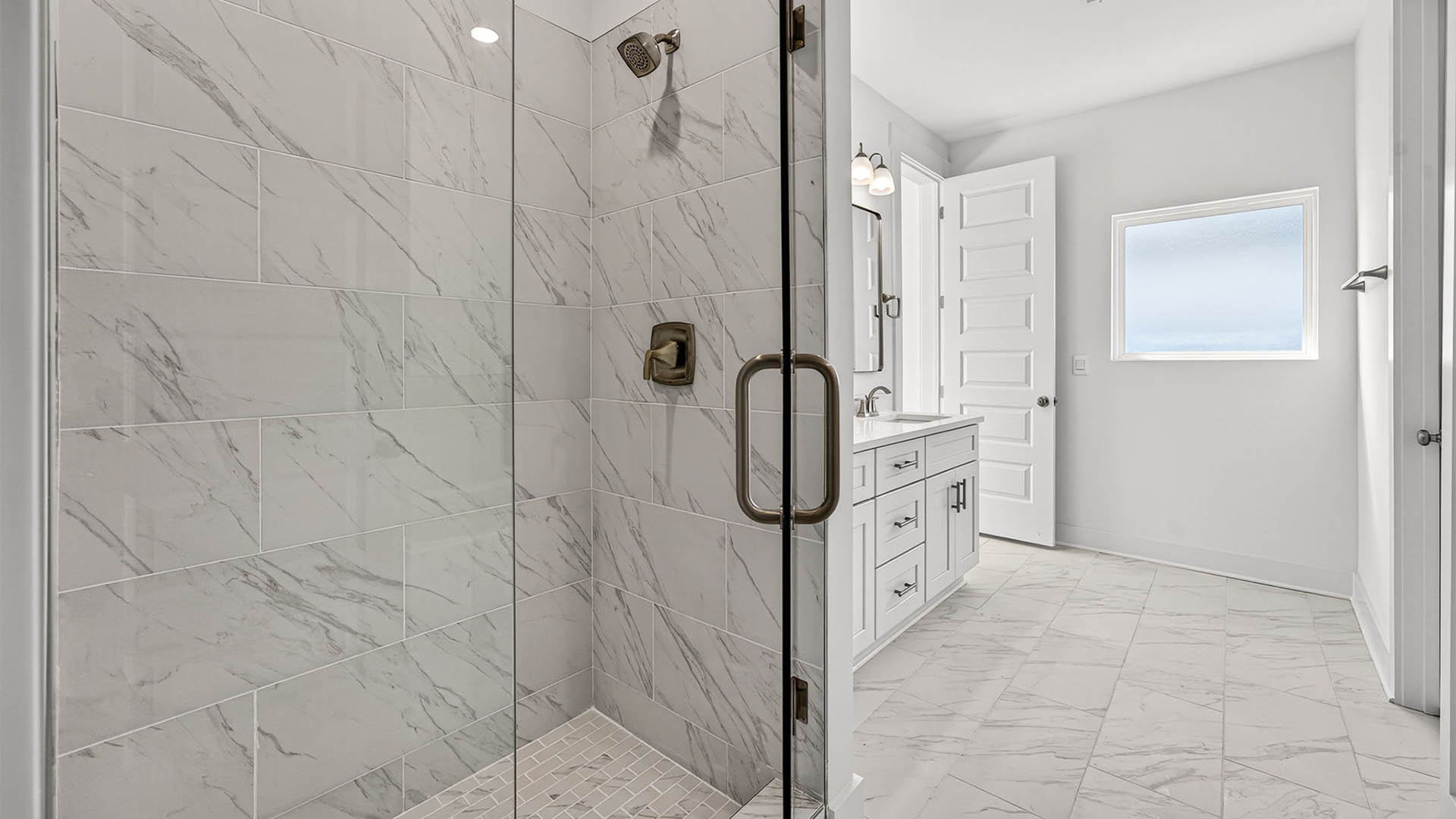 Tile shower with glass door and bathroom with tile floor.