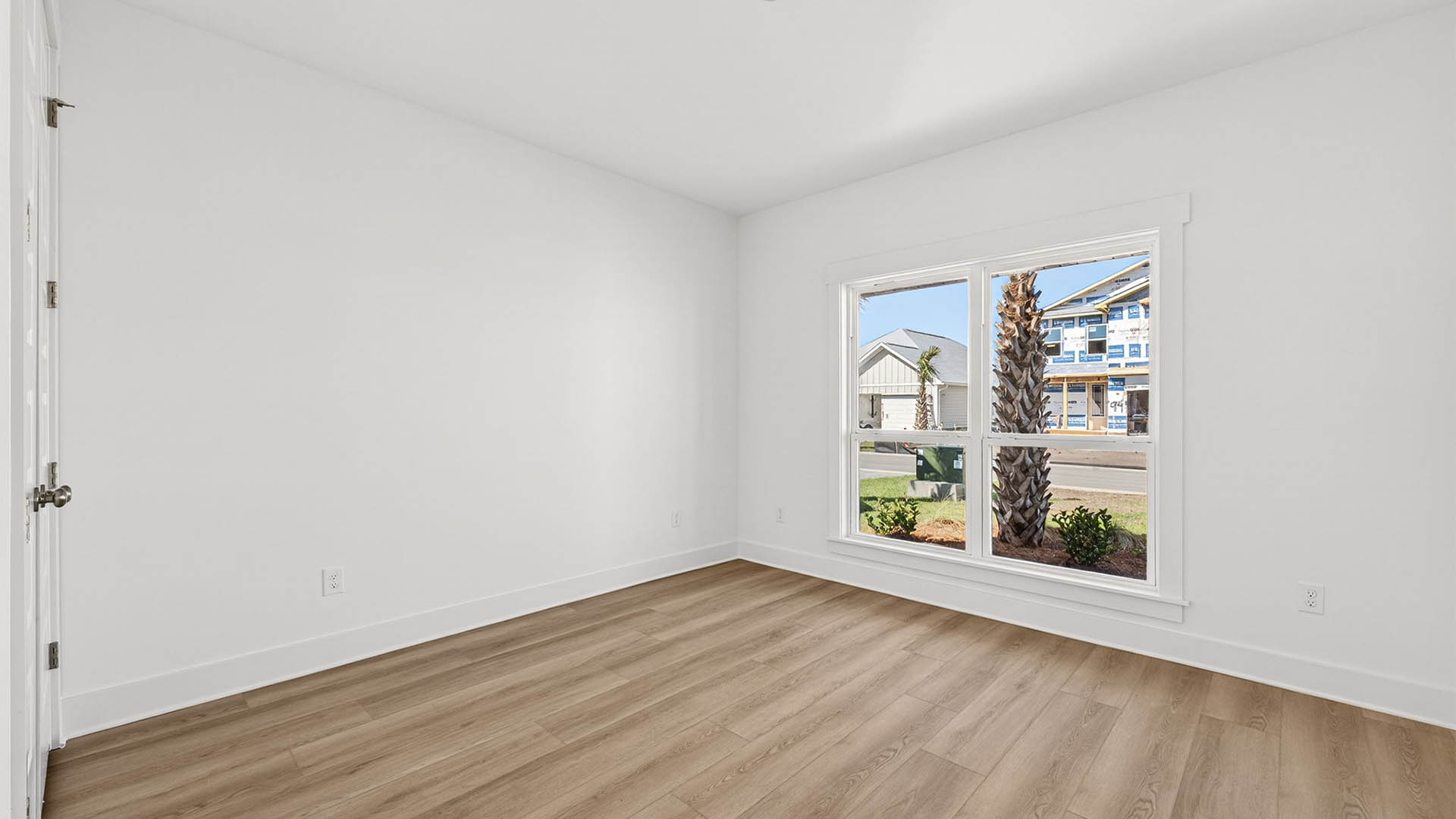 Bedroom with EVP flooring and window and closet.