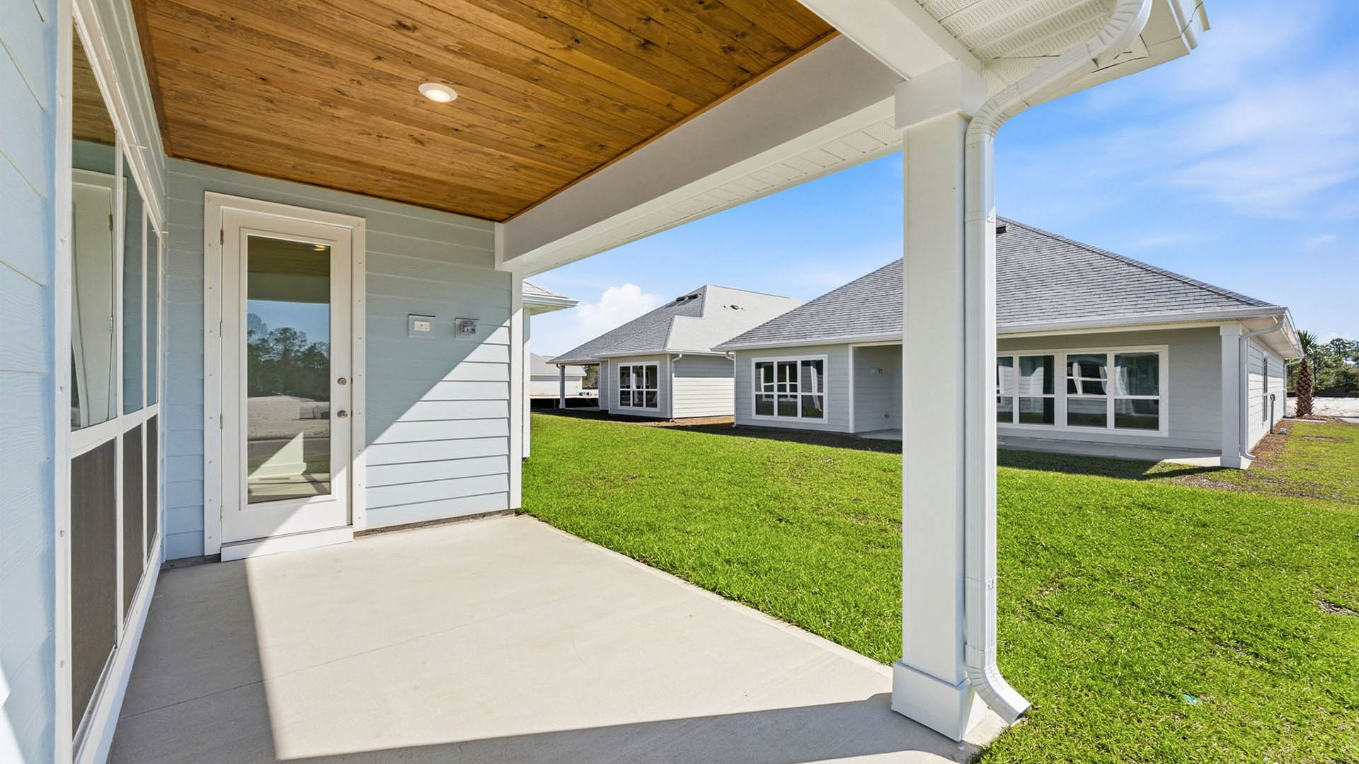 Lily plan rear of home with covered patio.