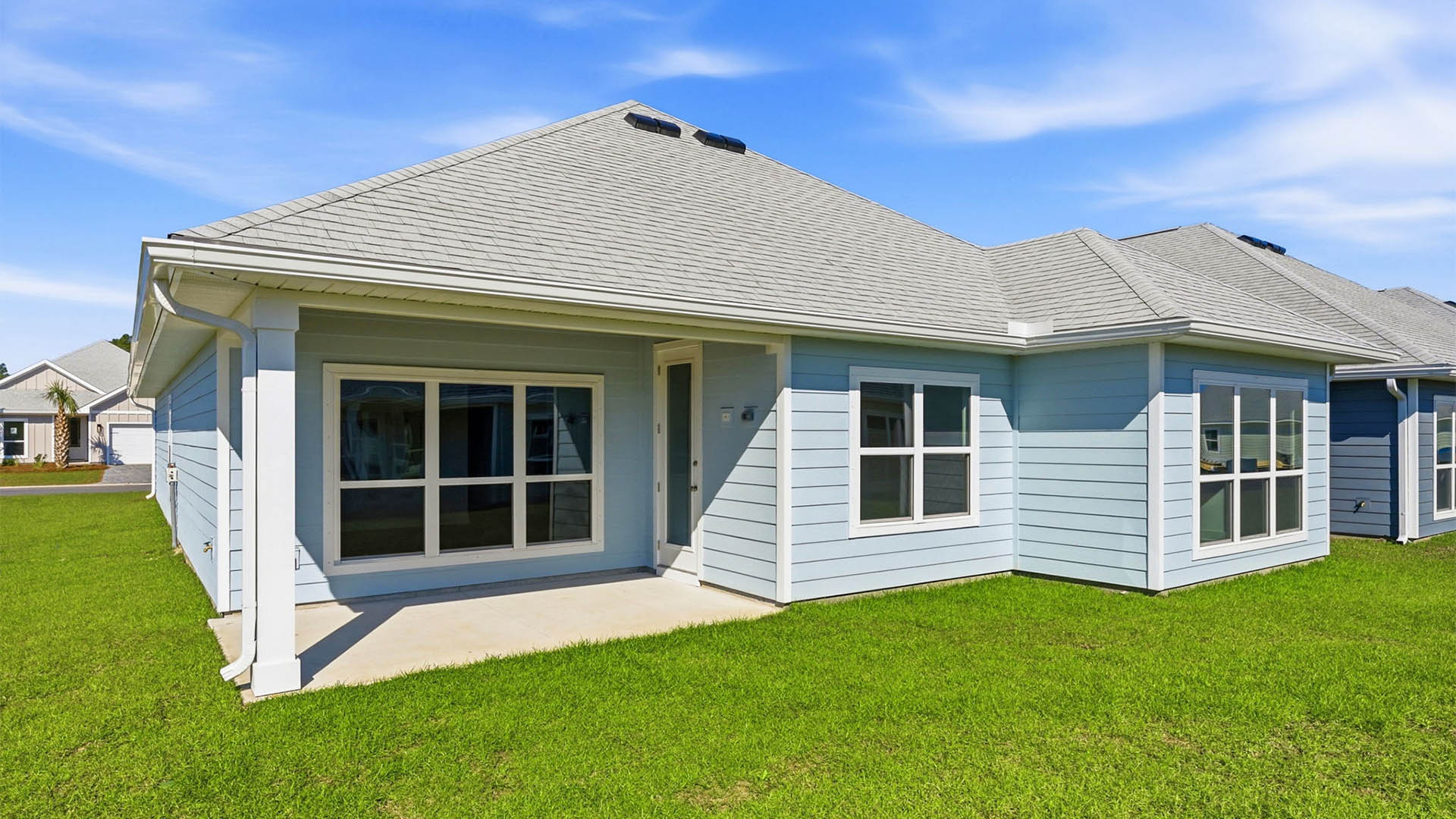 Lily plan rear of home with covered patio.