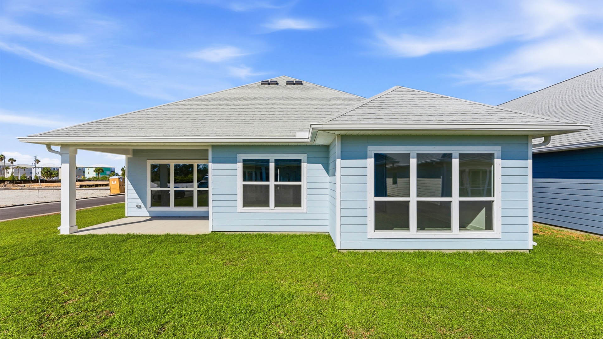 Lily plan rear of home with covered patio.