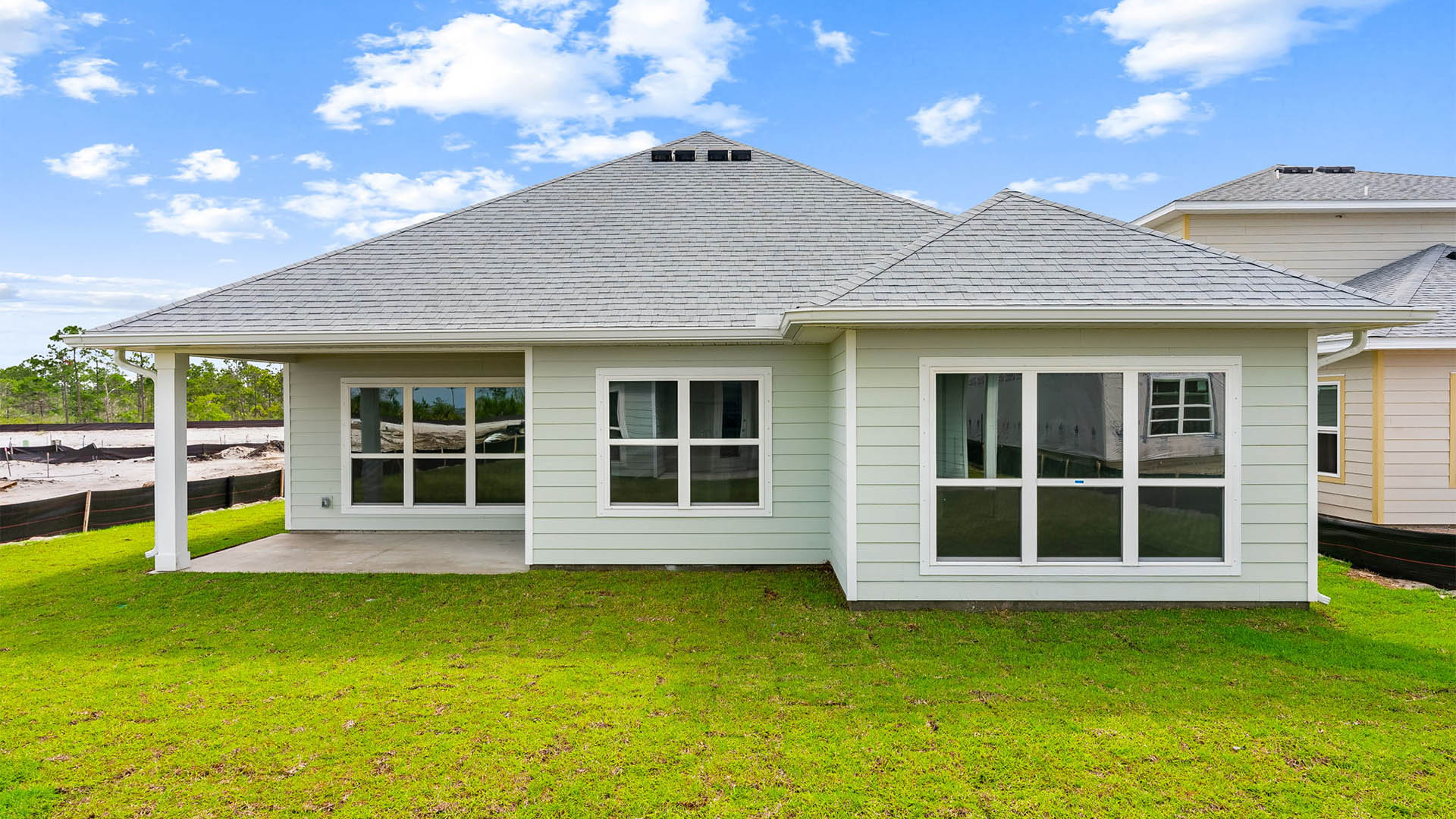 Lily plan rear of home with covered patio.