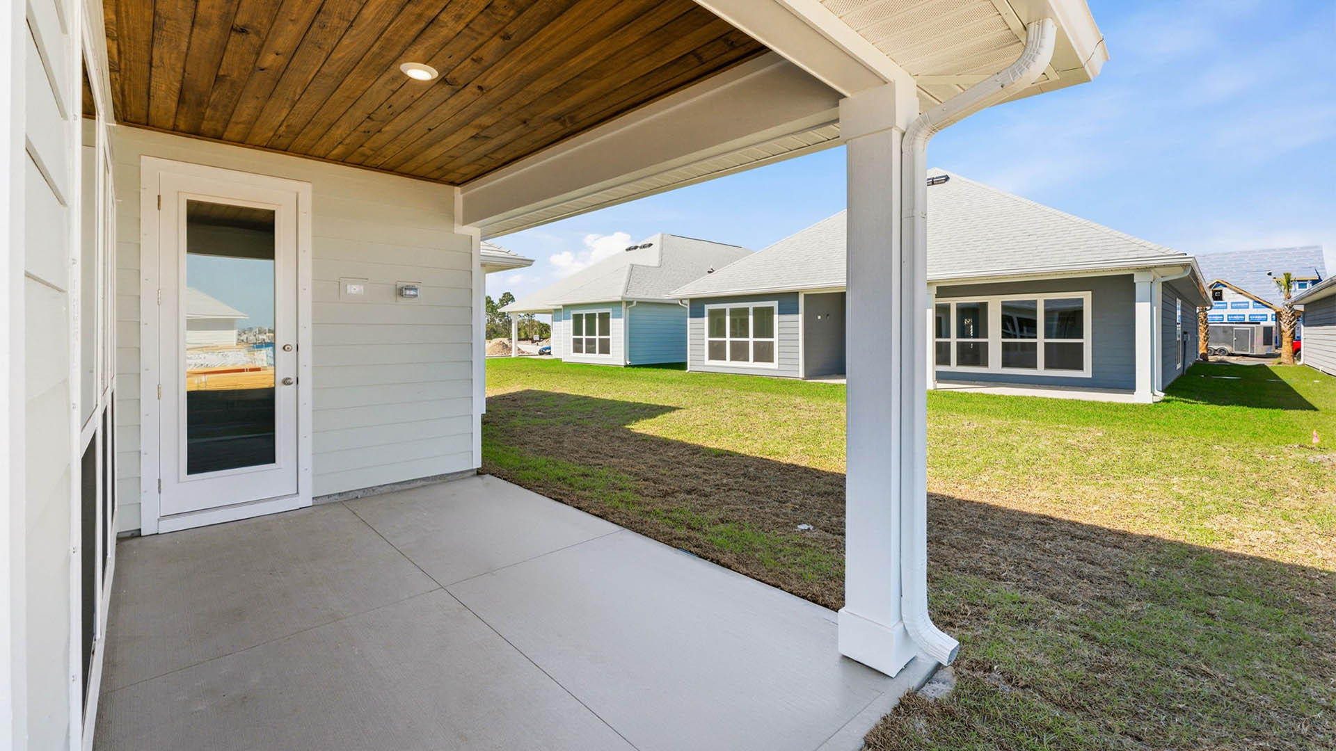 Lily plan rear of home with covered patio.