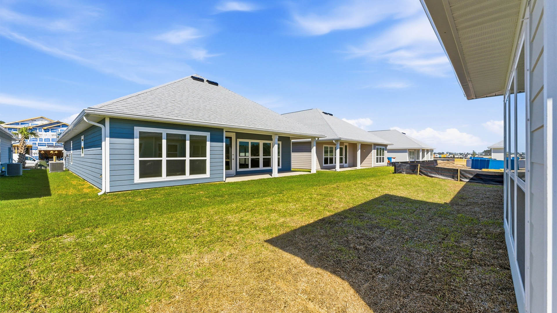 Lily plan rear of home with covered patio.