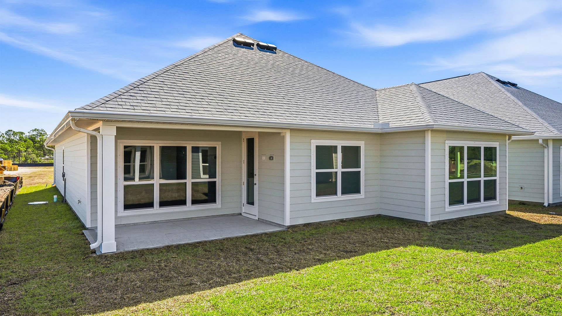Lily plan rear of home with covered patio.