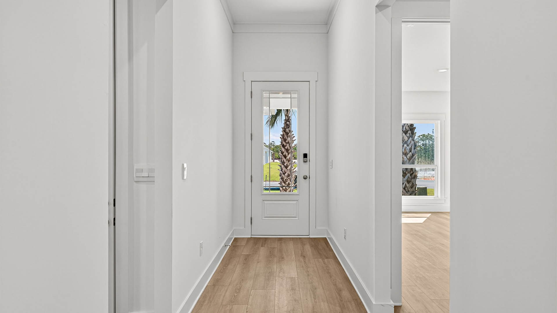 Front entrance next to bedrooms with prairie style front door.
