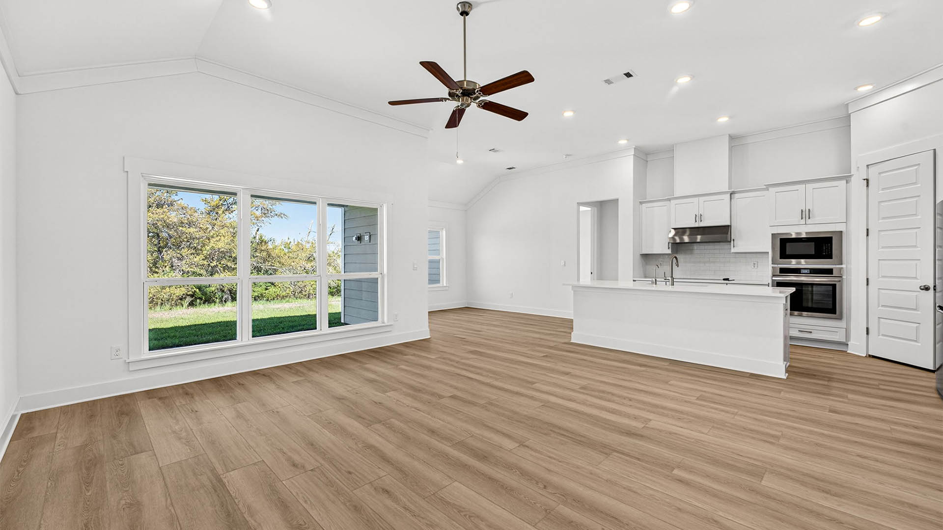 Open living room and kitchen with kitchen island.