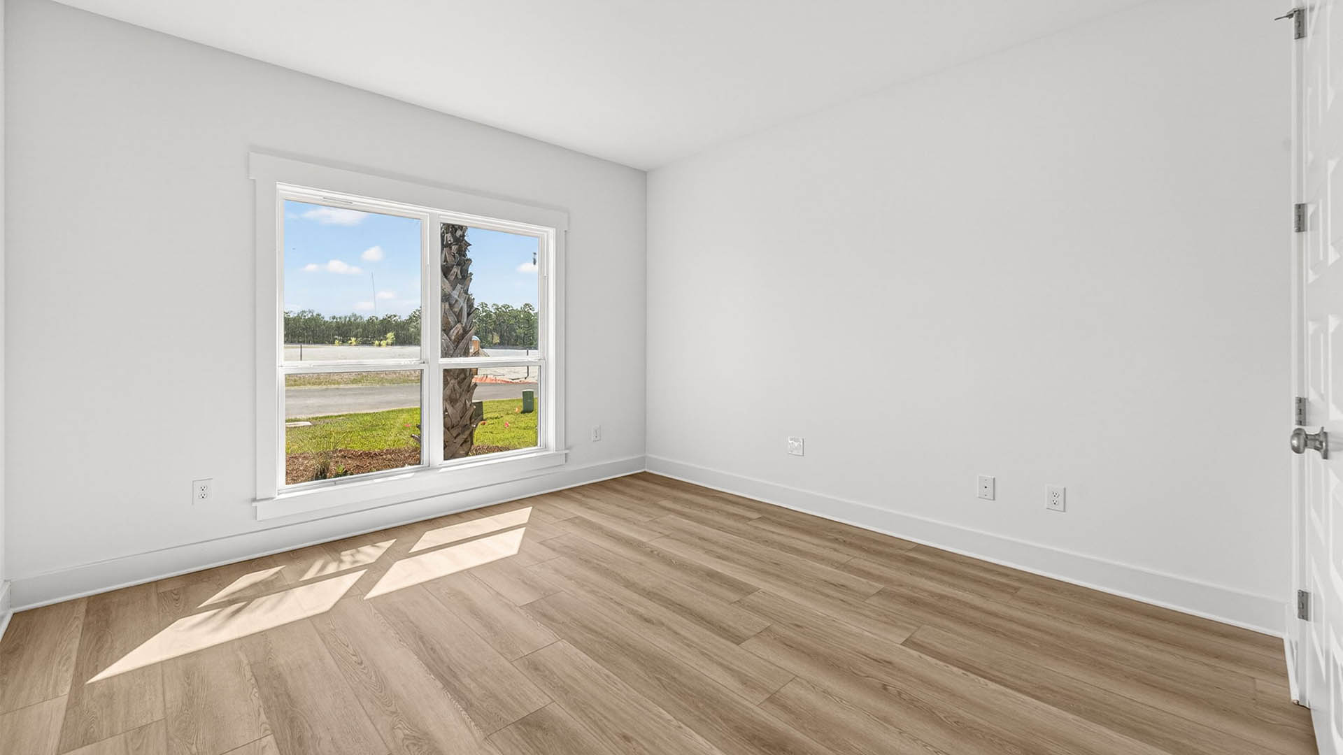 Bedroom with EVP flooring and window and closet.
