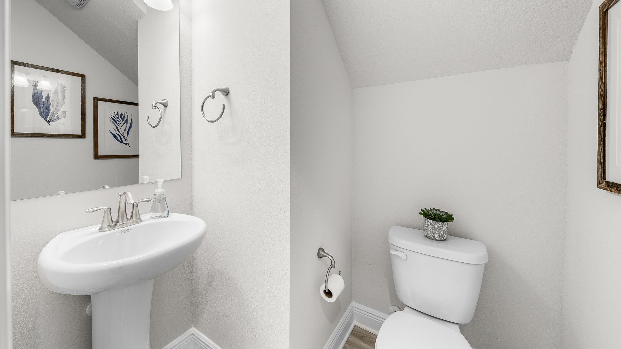 Half bathroom with single vanity sink and toilet.