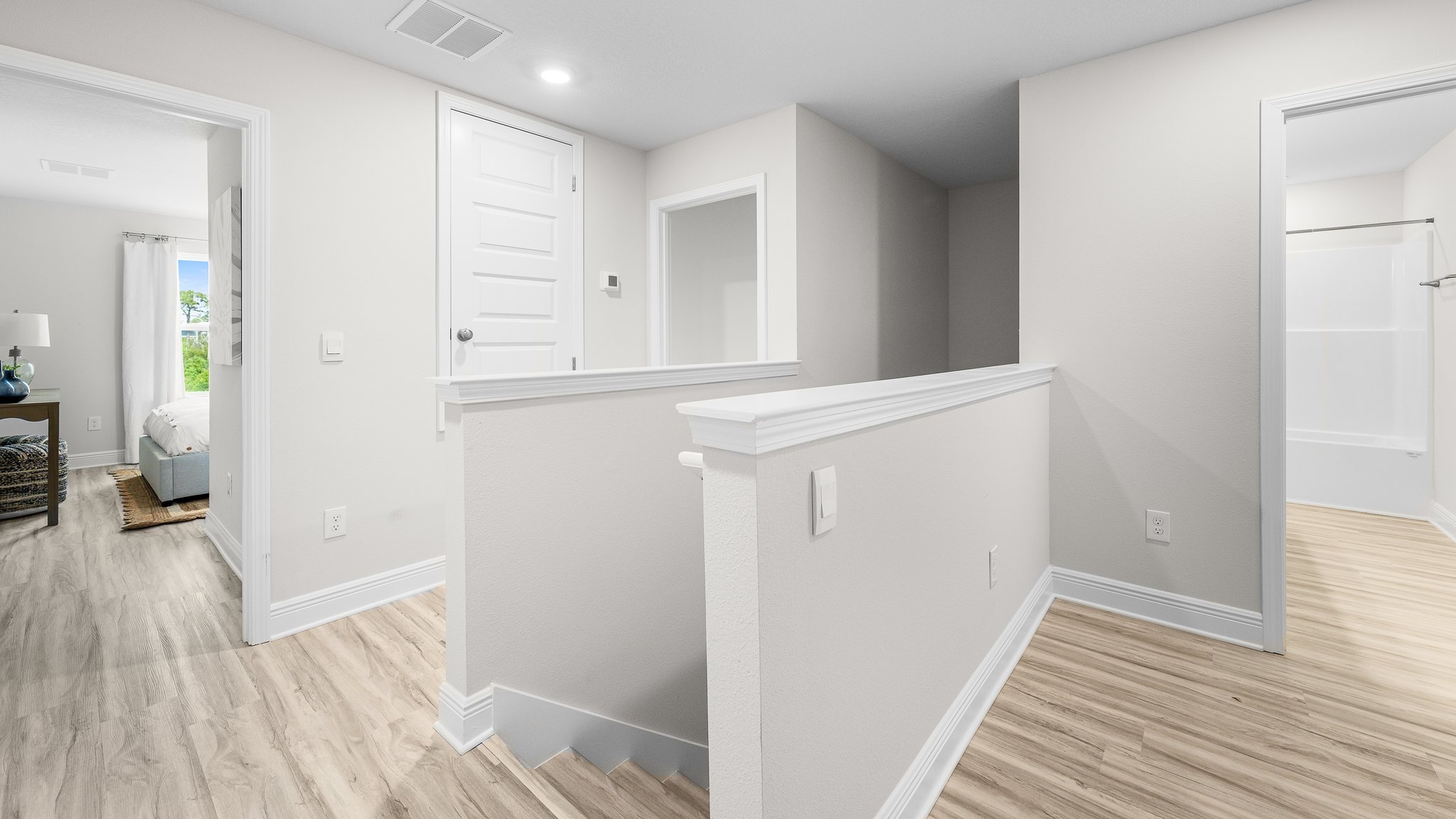 Upstairs hallway next to stairs with EVP flooring.