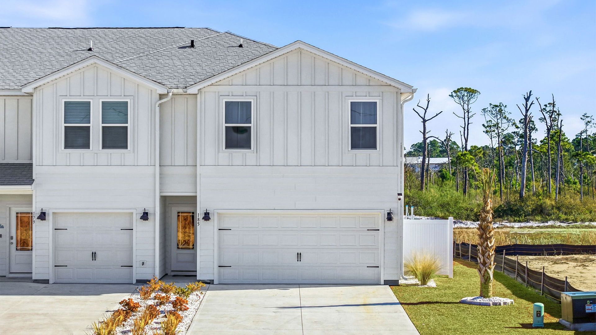 Two-Story Sabal townhome with 2-car garage and white Hardie Board siding.