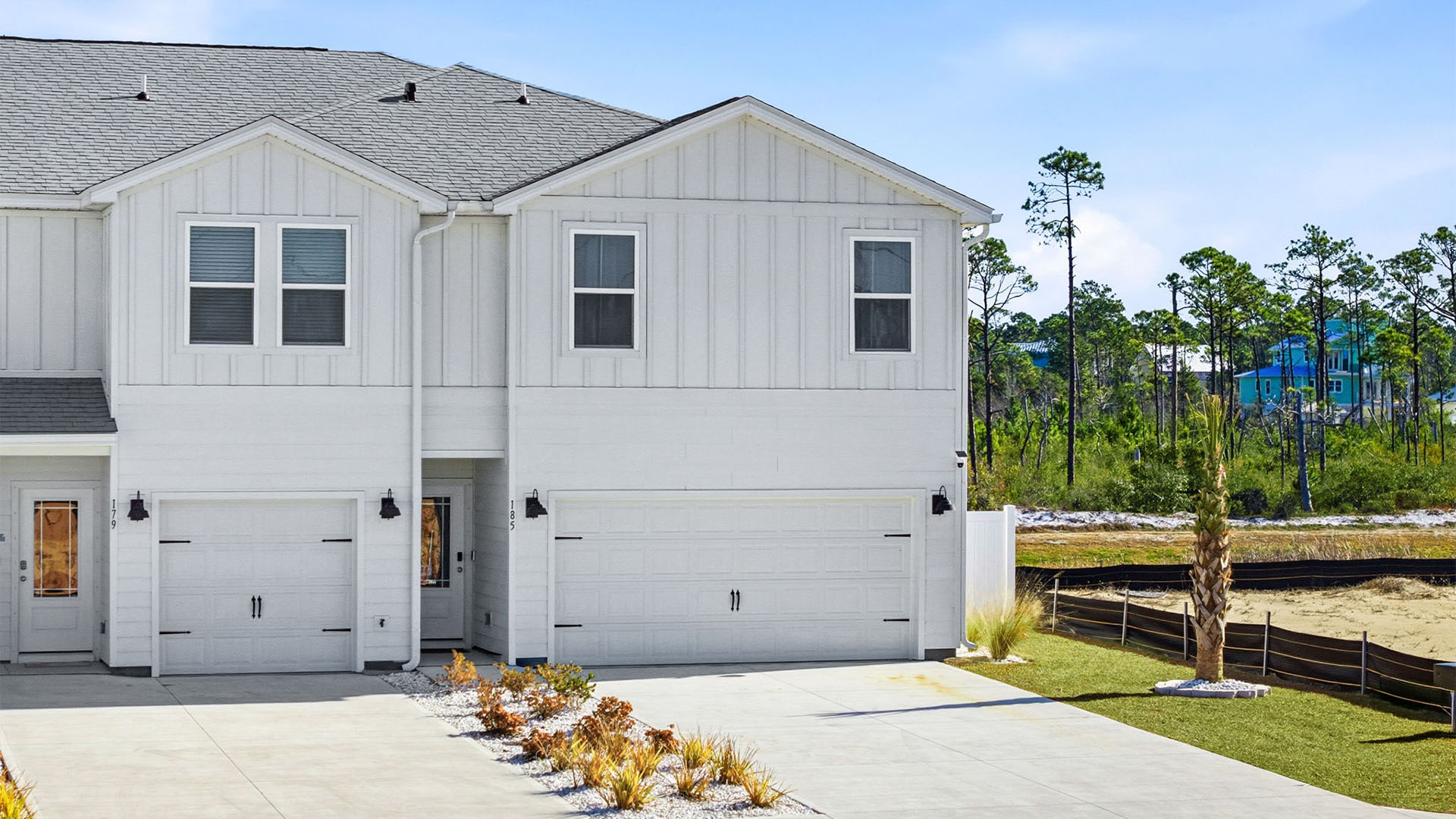 Two-Story Sabal townhome with 2-car garage and white Hardie Board siding.