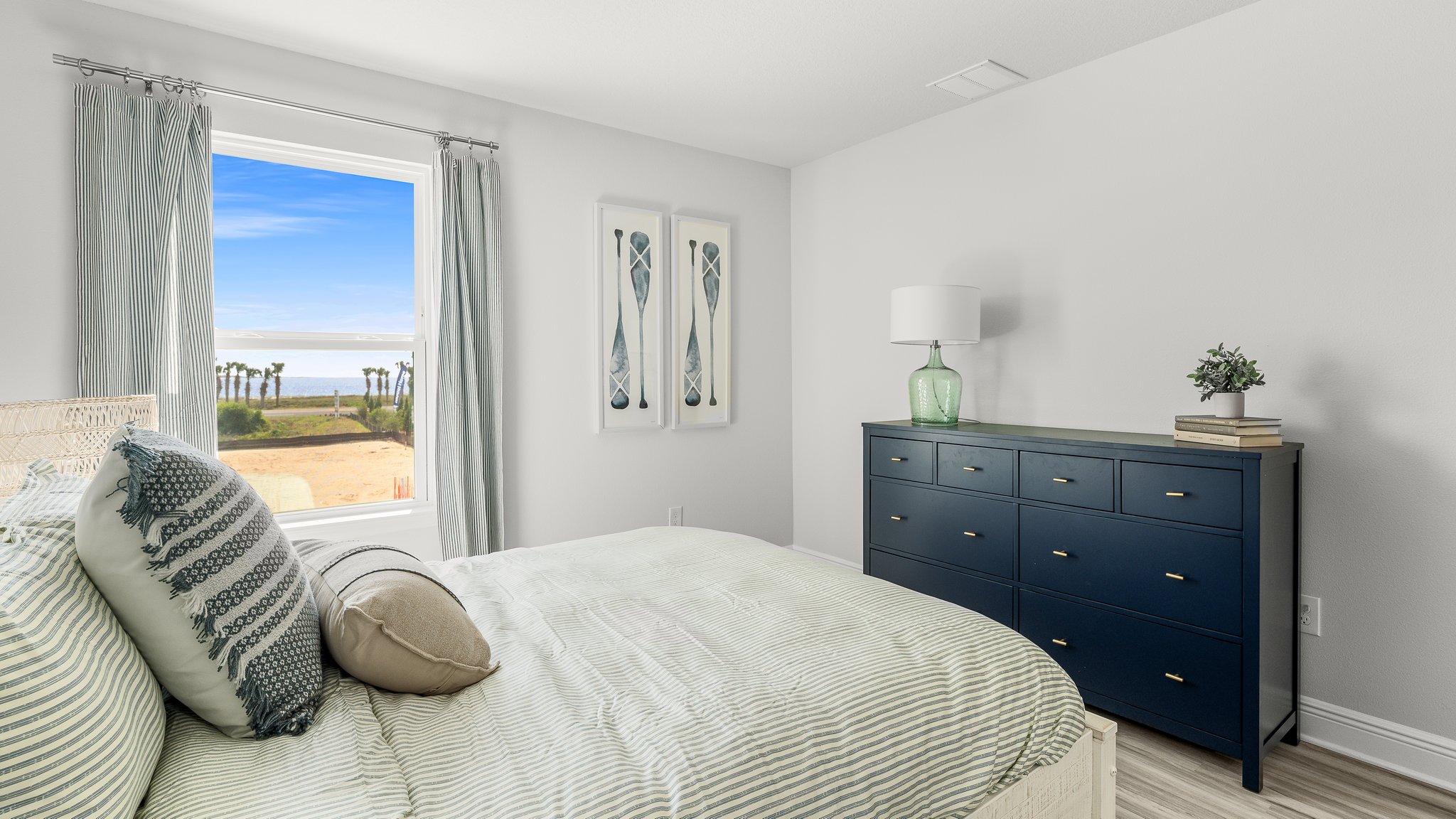 Bedroom with EVP flooring and windows.