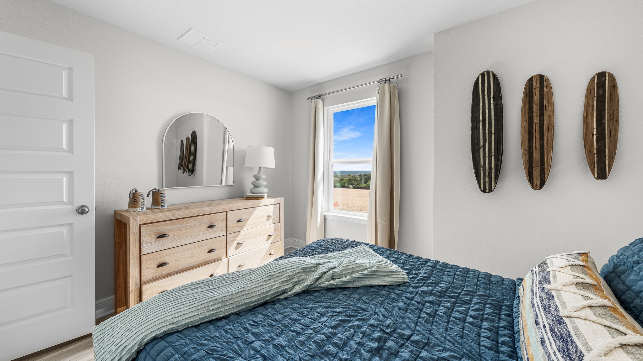 Bedroom with EVP flooring and windows.