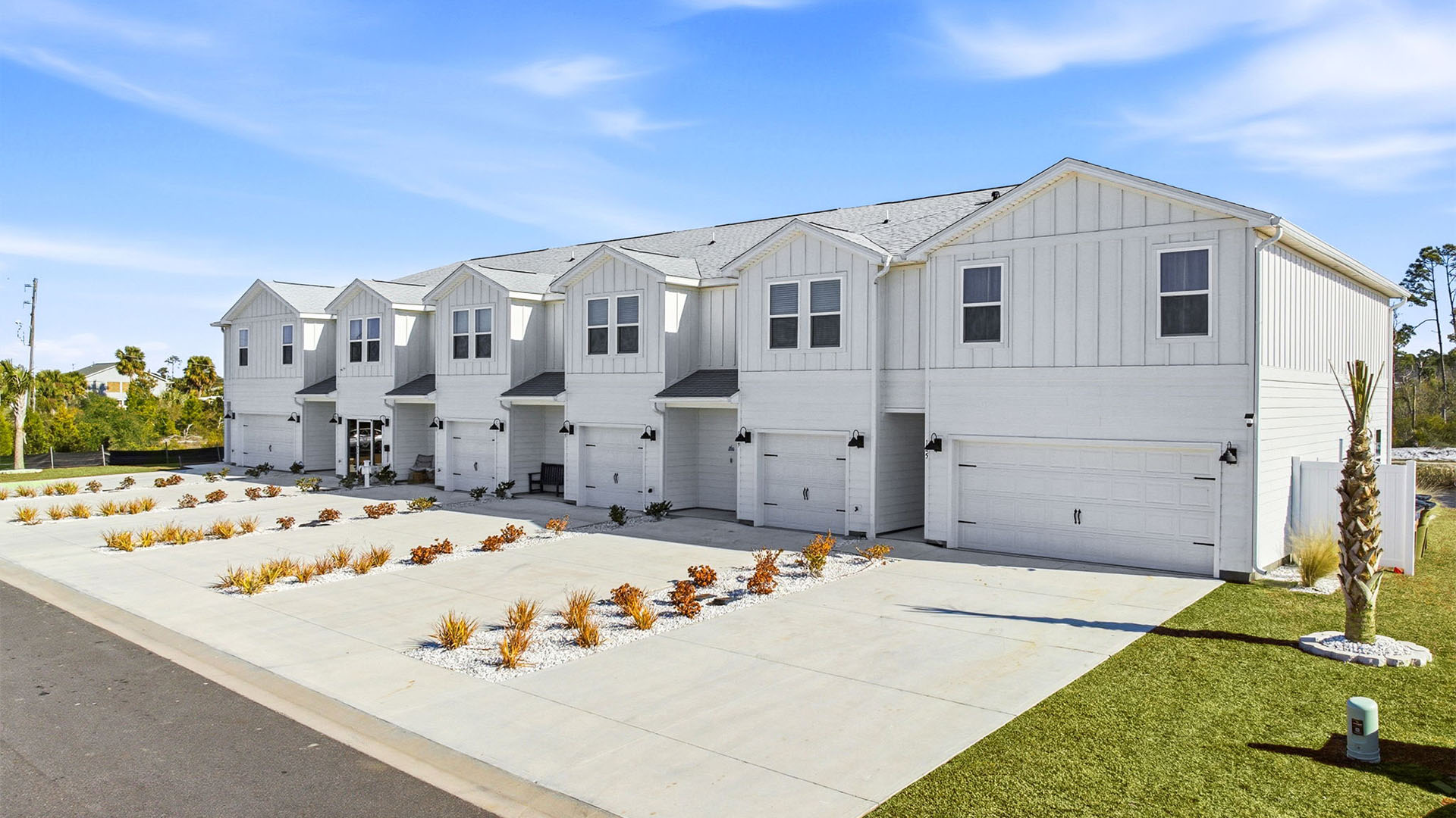 Sabal Townhome exterior unit at WindMark Beach with Hardie Board siding and two car garage.