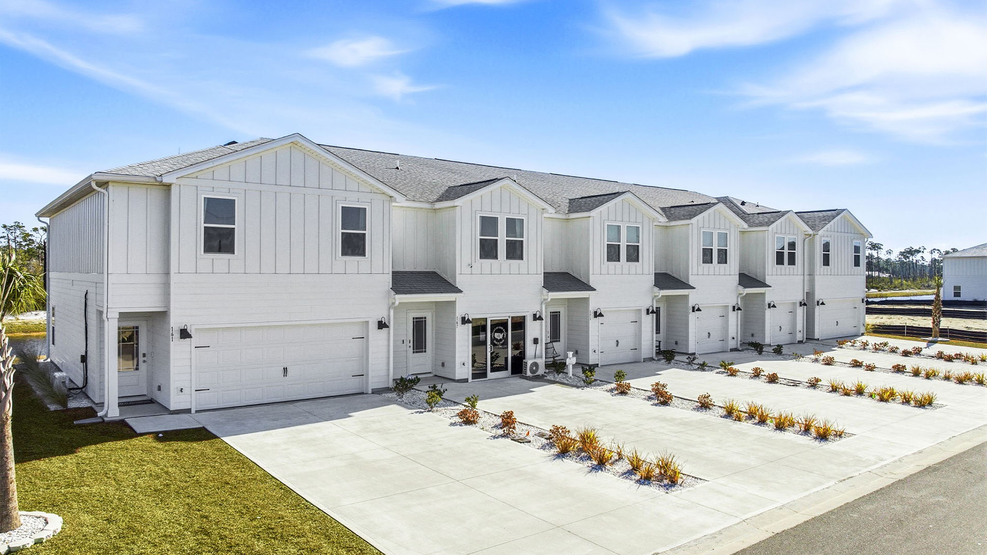 Sabal Townhome exterior unit at WindMark Beach with Hardie Board siding and two car garage.