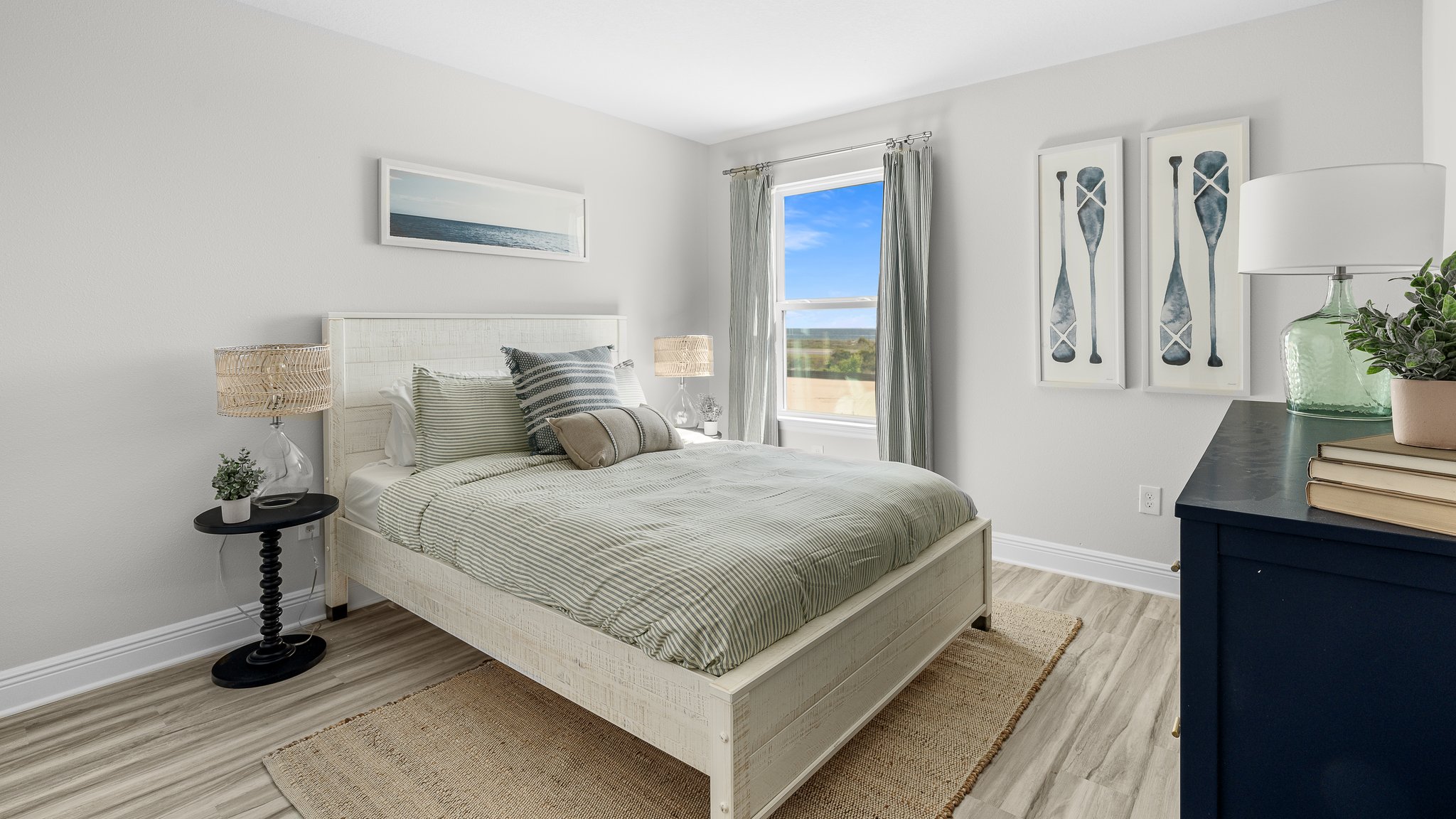Bedroom with EVP flooring and windows.