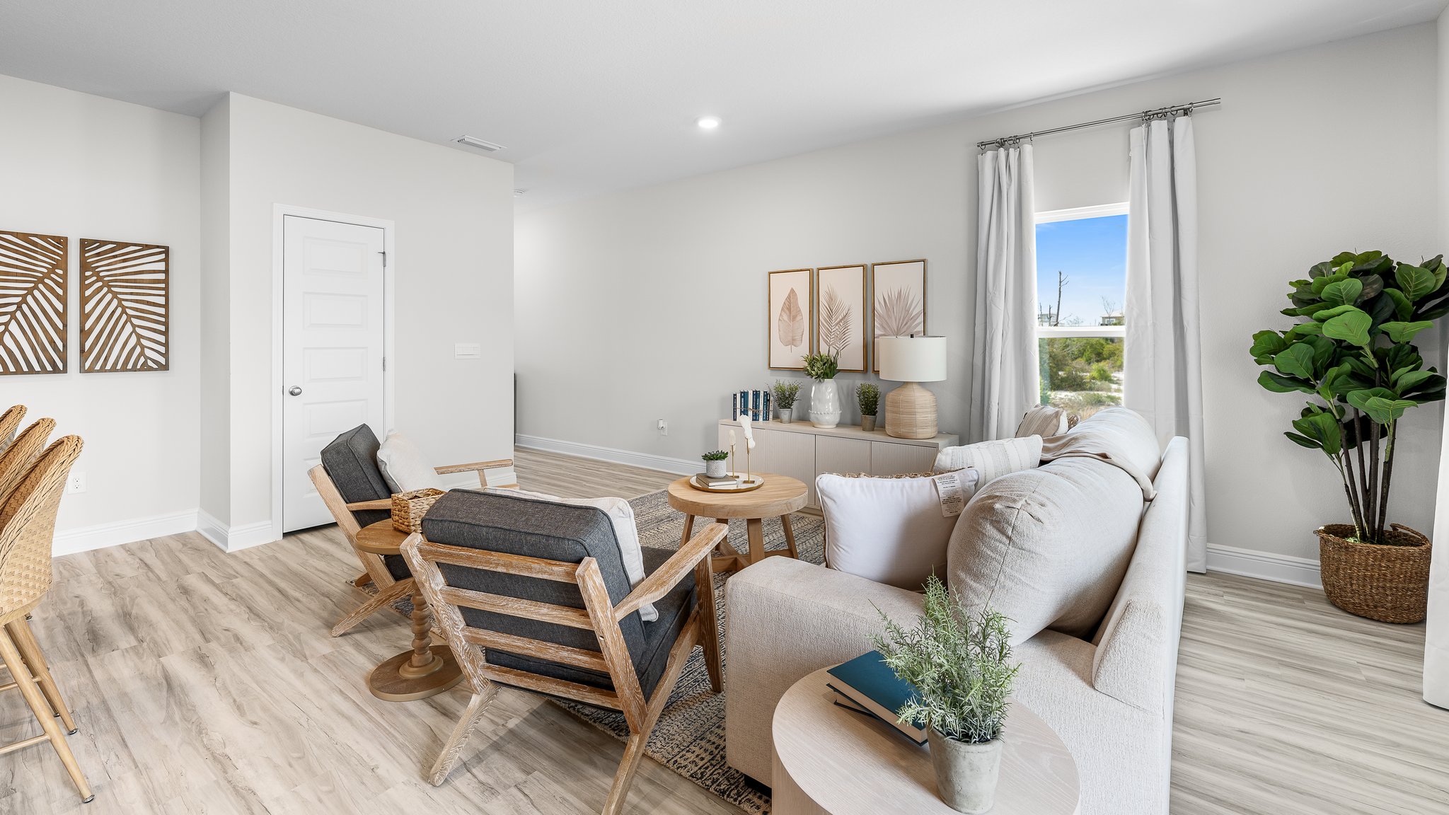 Open living room with EVP flooring and windows.