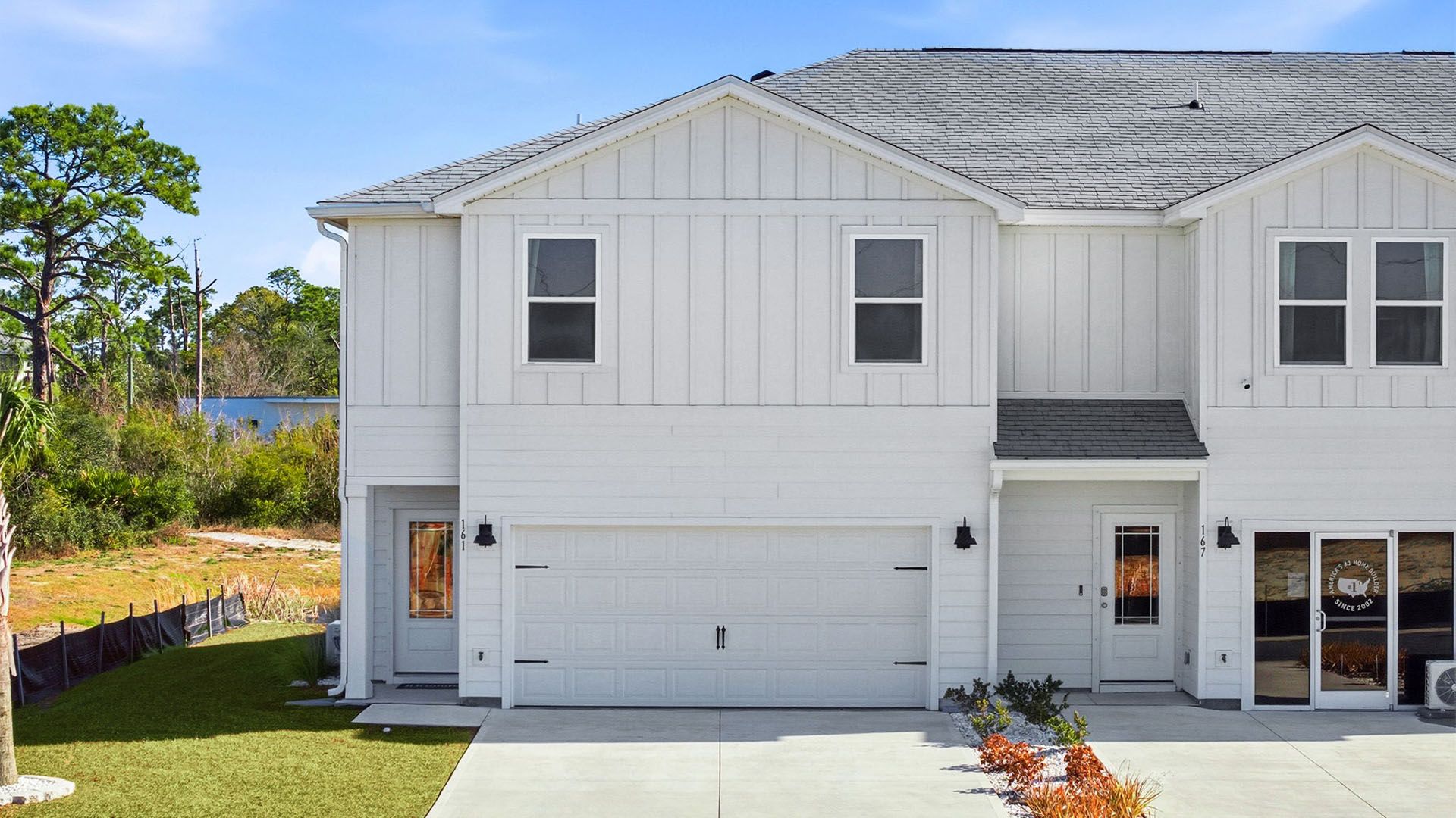 Sabal Townhome exterior unit at WindMark Beach with Hardie Board siding and two car garage.