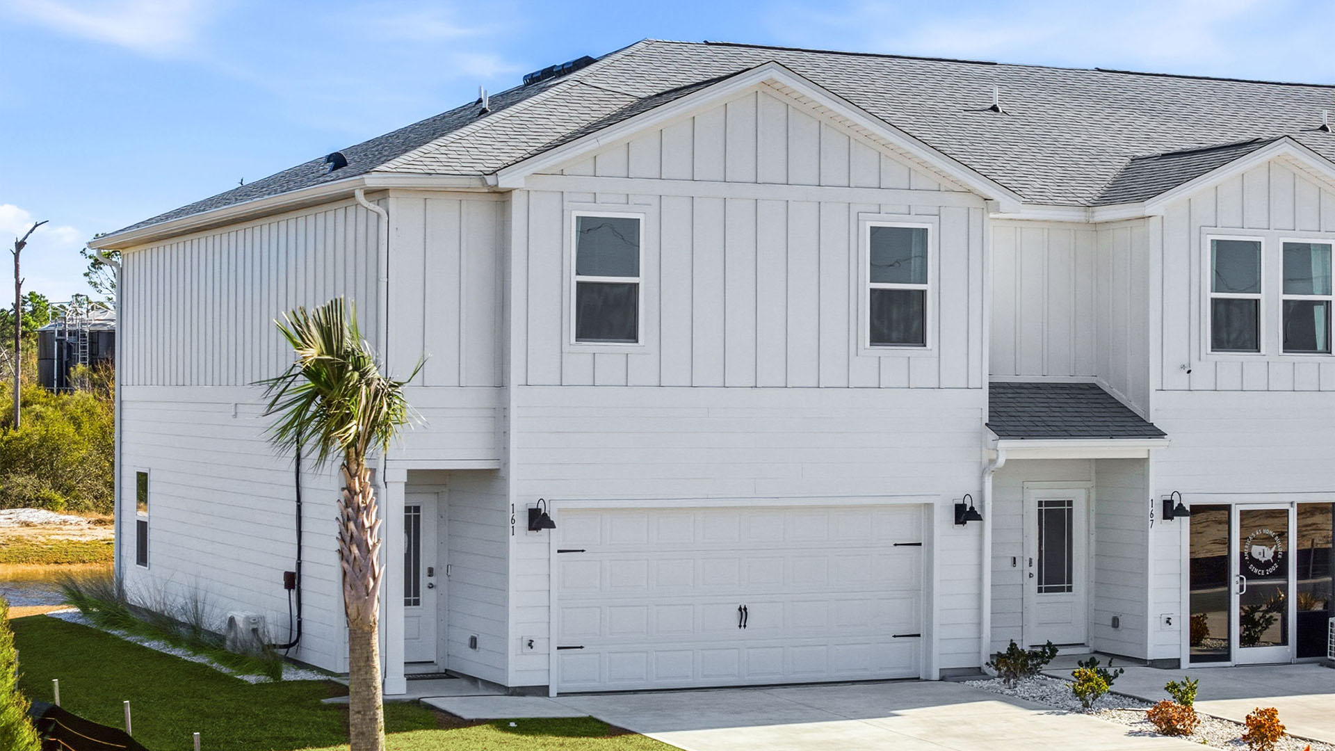 Sabal Townhome exterior unit at WindMark Beach with Hardie Board siding and two car garage.