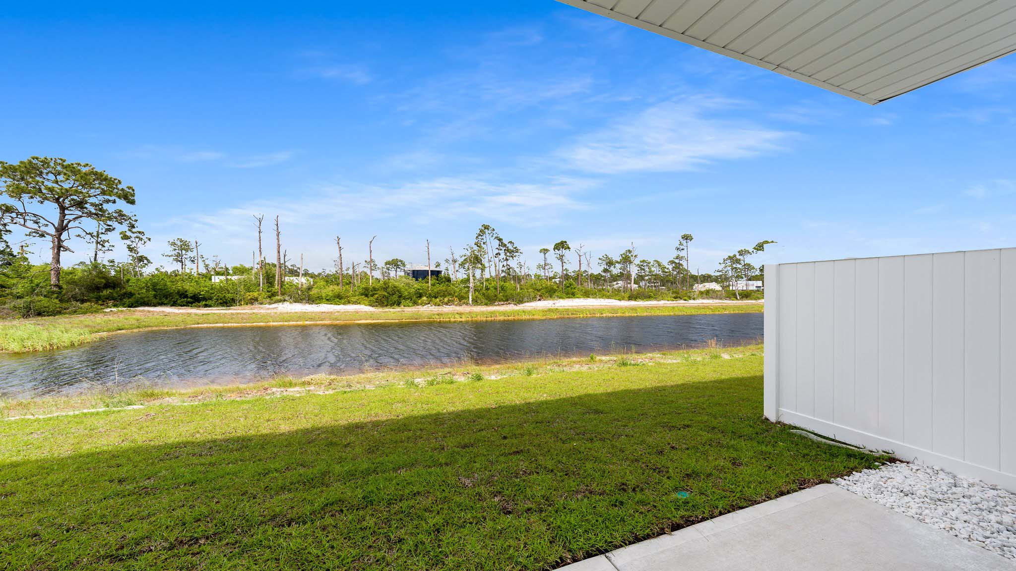Covered rear patio view looking at pond.
