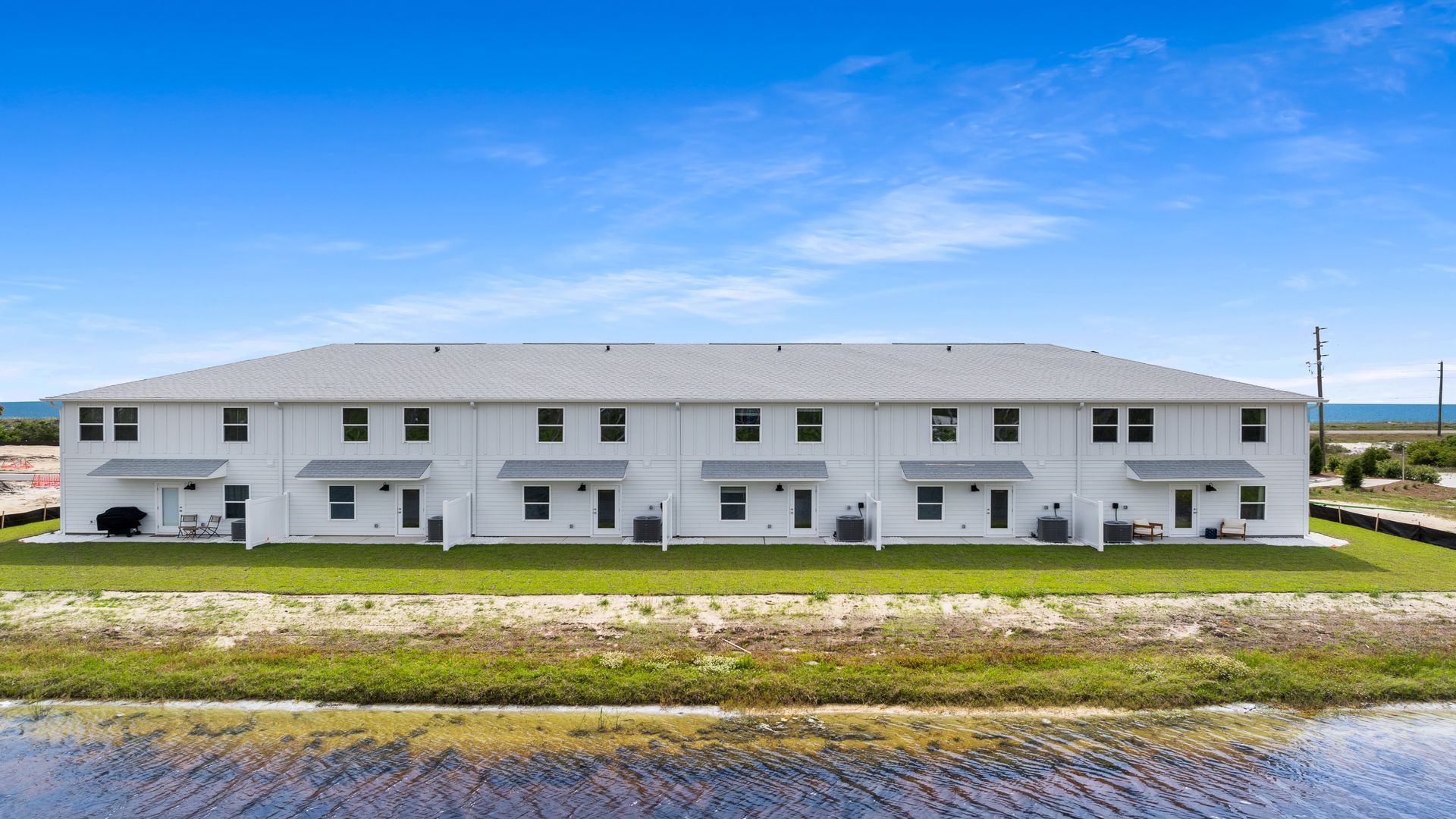 Sabal Townhome units rear of home with covered patios and partitions.