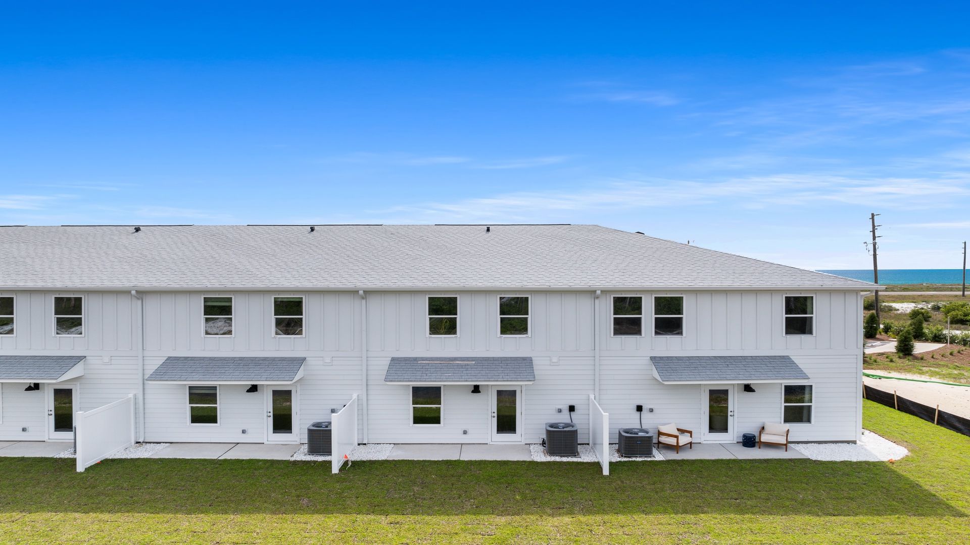 Sabal Townhome units rear of home with covered patios and partitions.