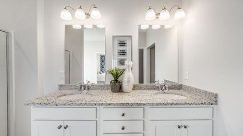 Hodges Bayou Plantation model home bathroom with granite countertops and double vanity.