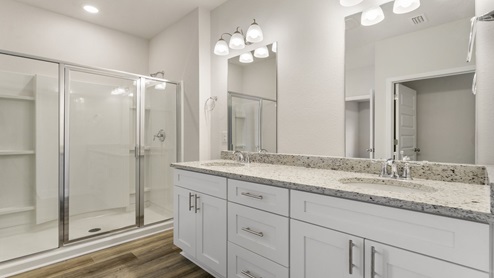 Master bathroom with granite countertops and shower and tub.